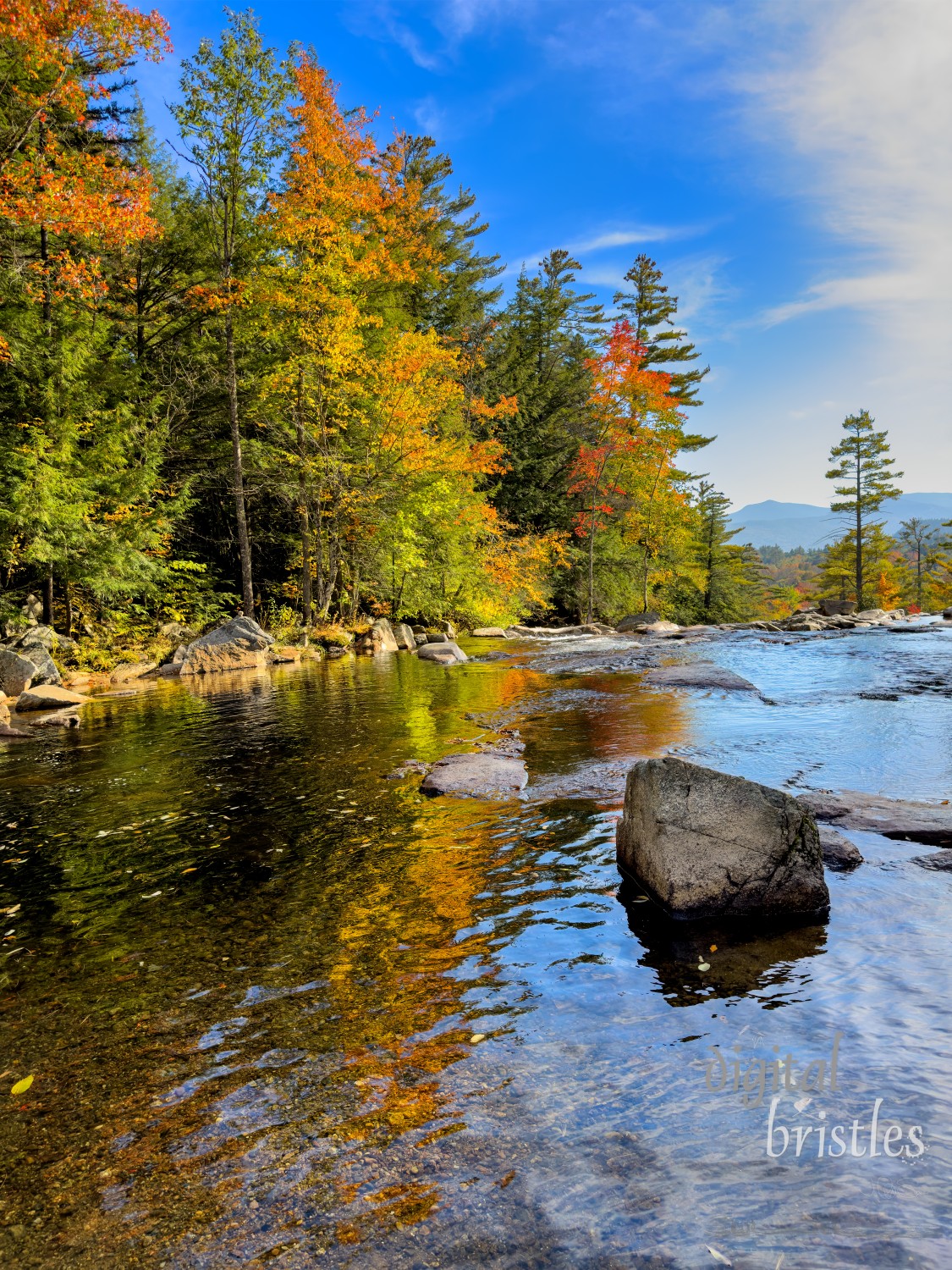 Calm sections of the river reflect vivid foliage colors. Jackson, New Hampshire