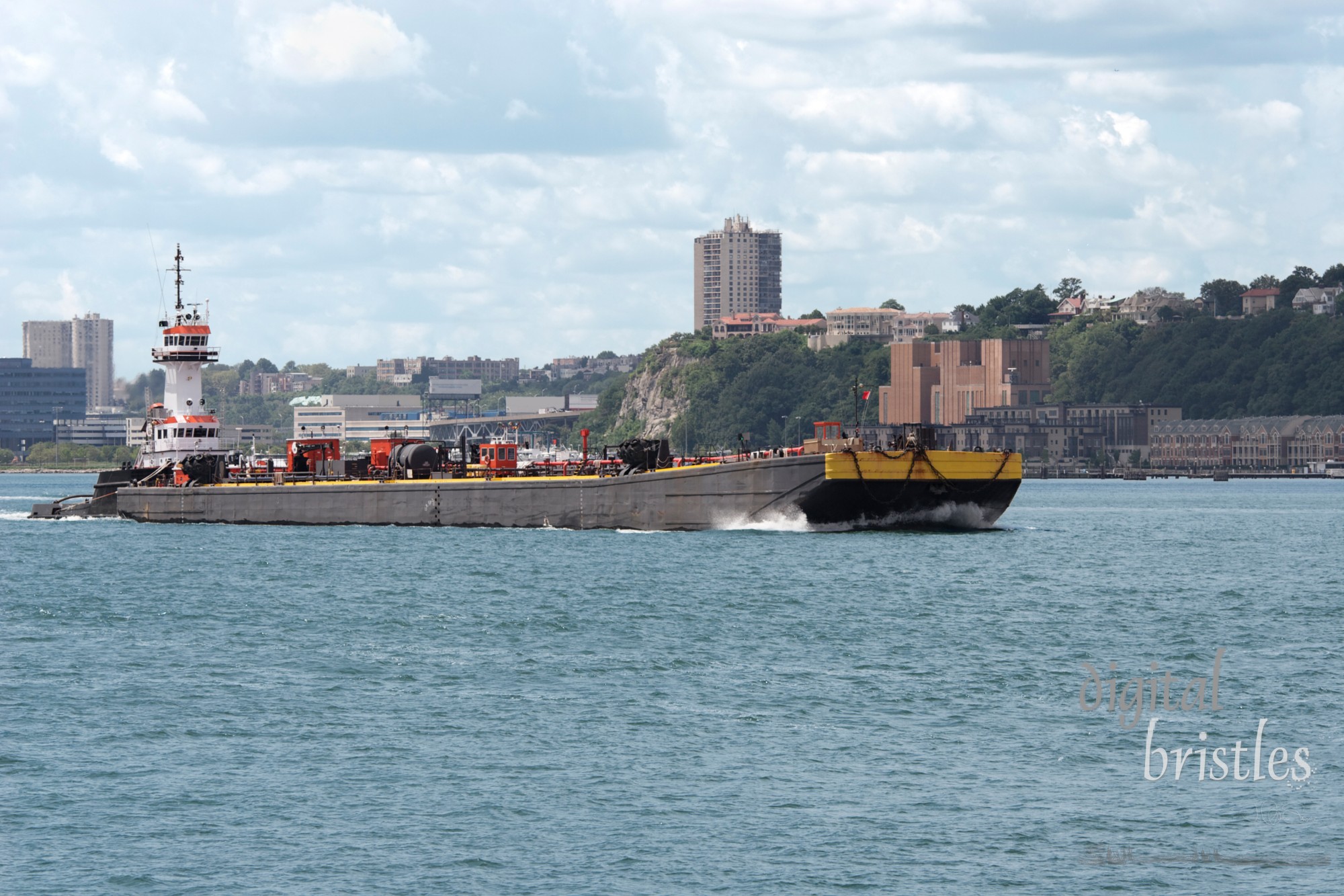 Tug boat pushing a barge up the Hudson River, New York