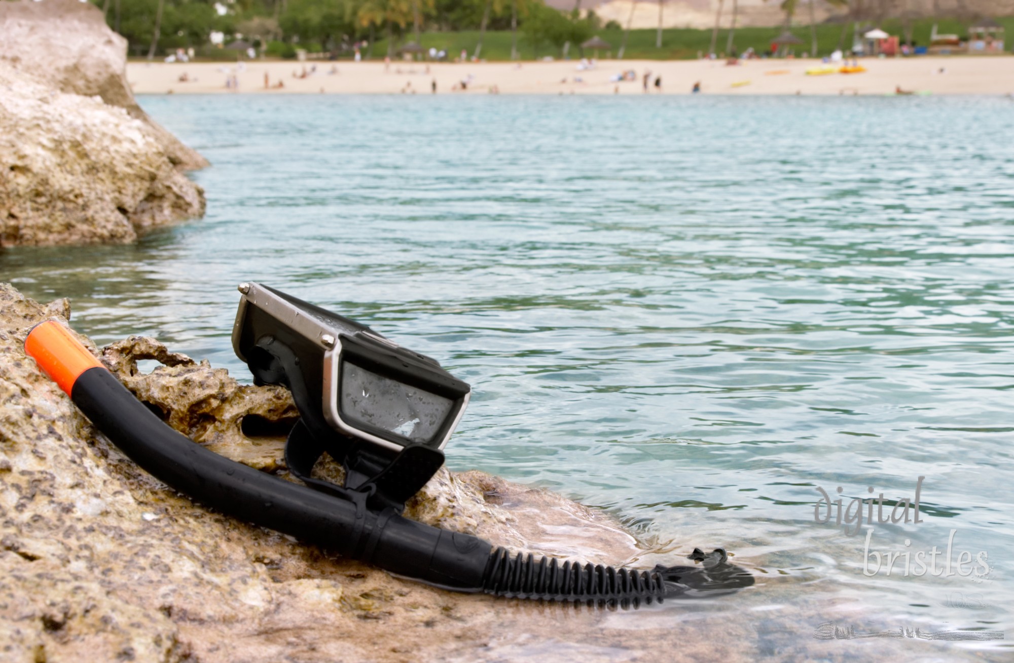 Mask and snorkel on the rocks, beach in background