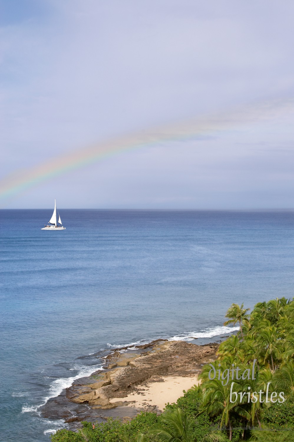 Sailboat heads under the rainbow