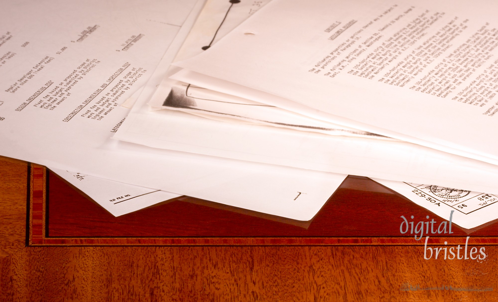 Papers strewn across wood desk