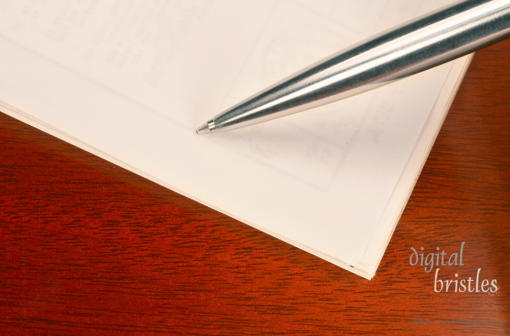 Pen and papers on a wooden desk