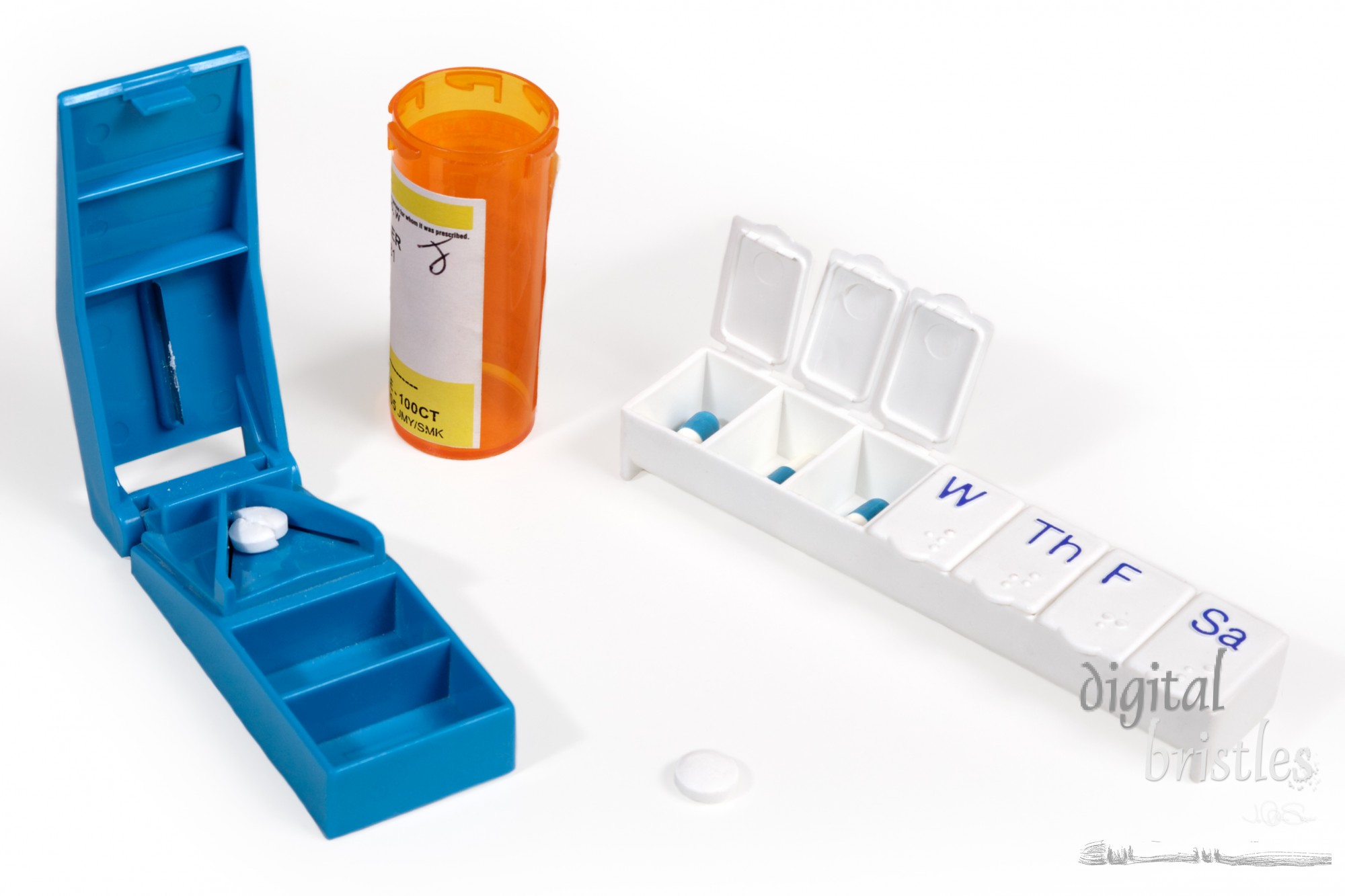 Pill cutter and weekly storage box with medicine bottle and pills