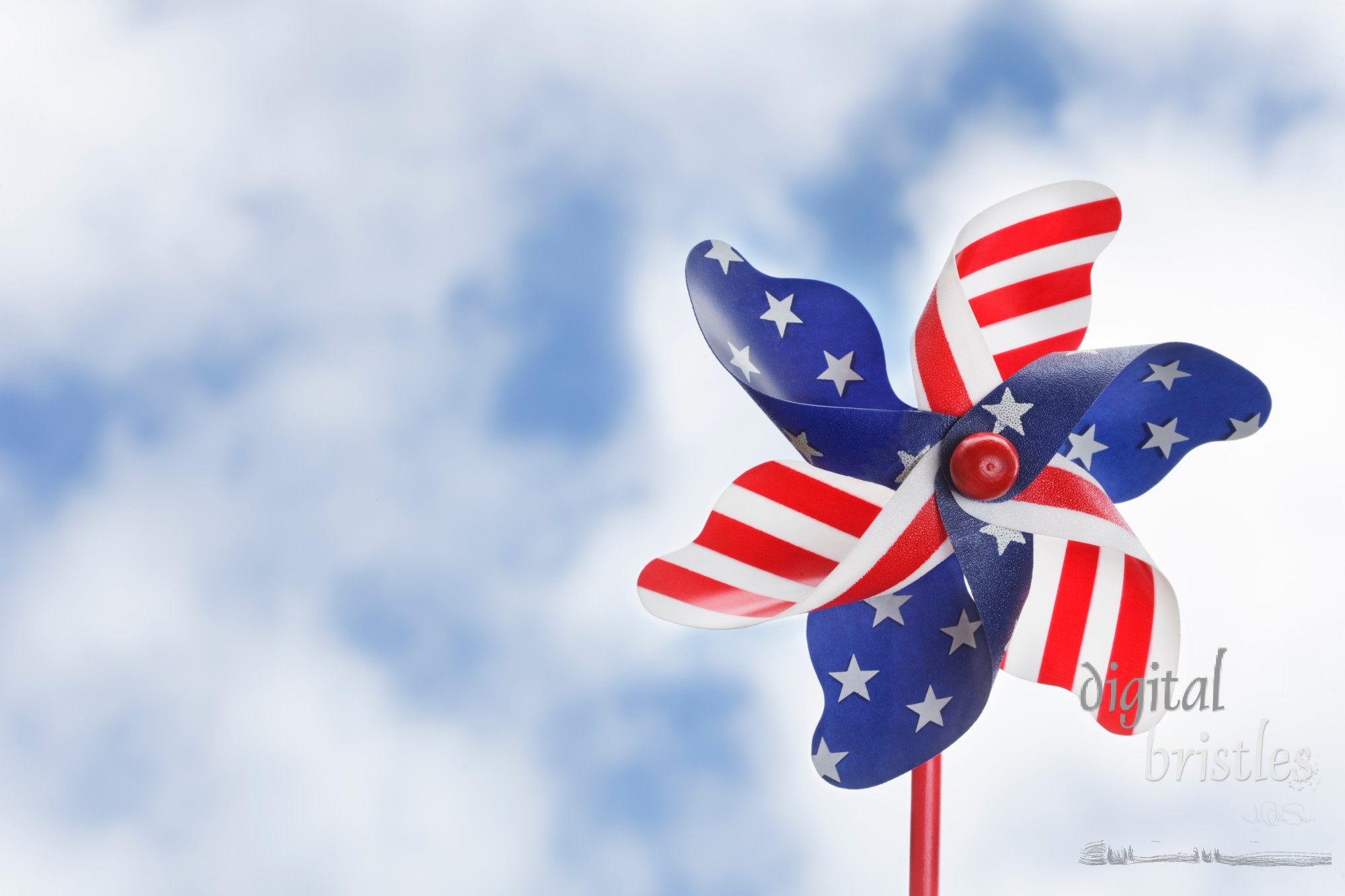 Stars & stripes pinwheel against a summery sky