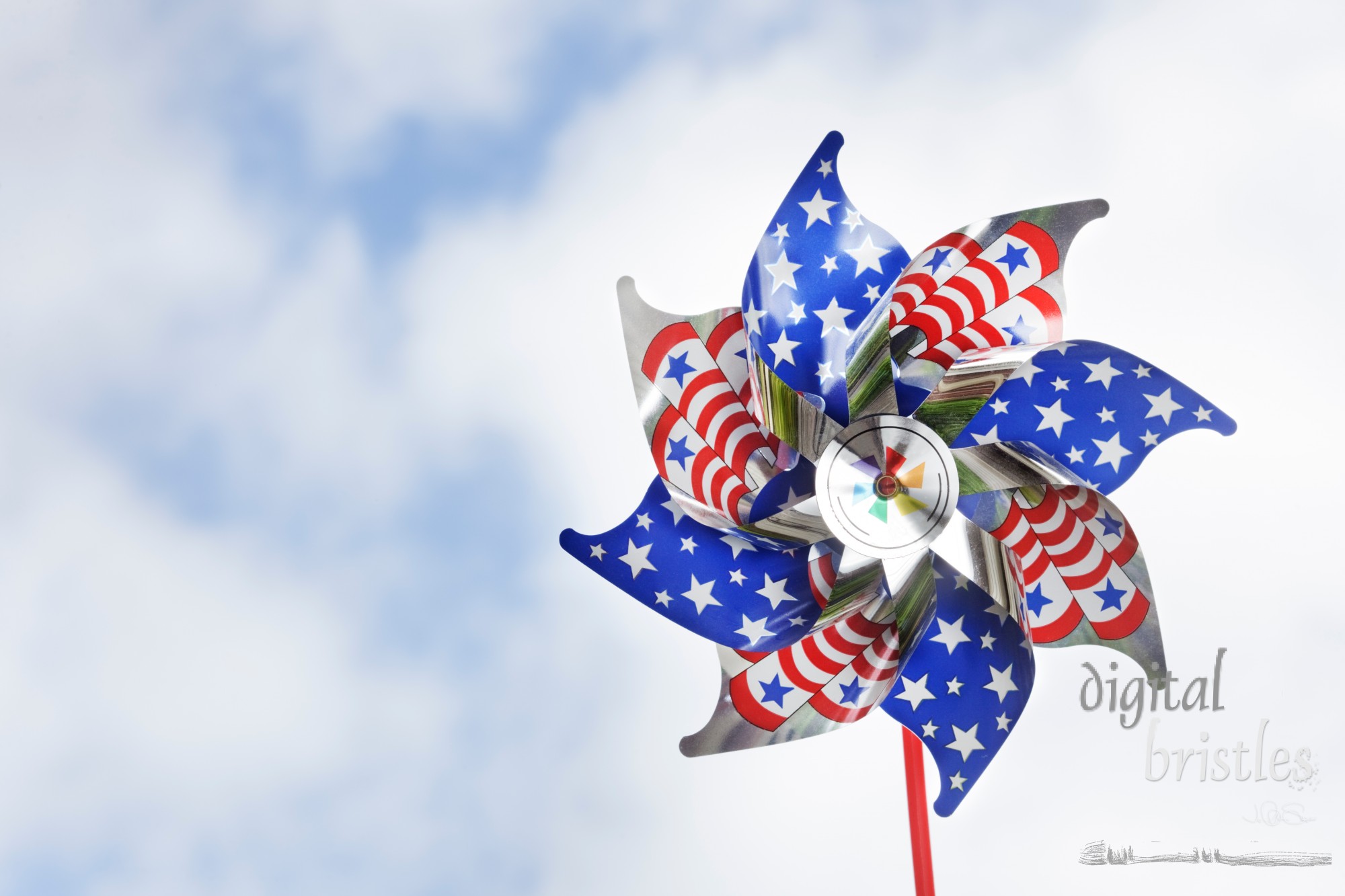 Shiny stars & stripes pinwheel against a summery sky