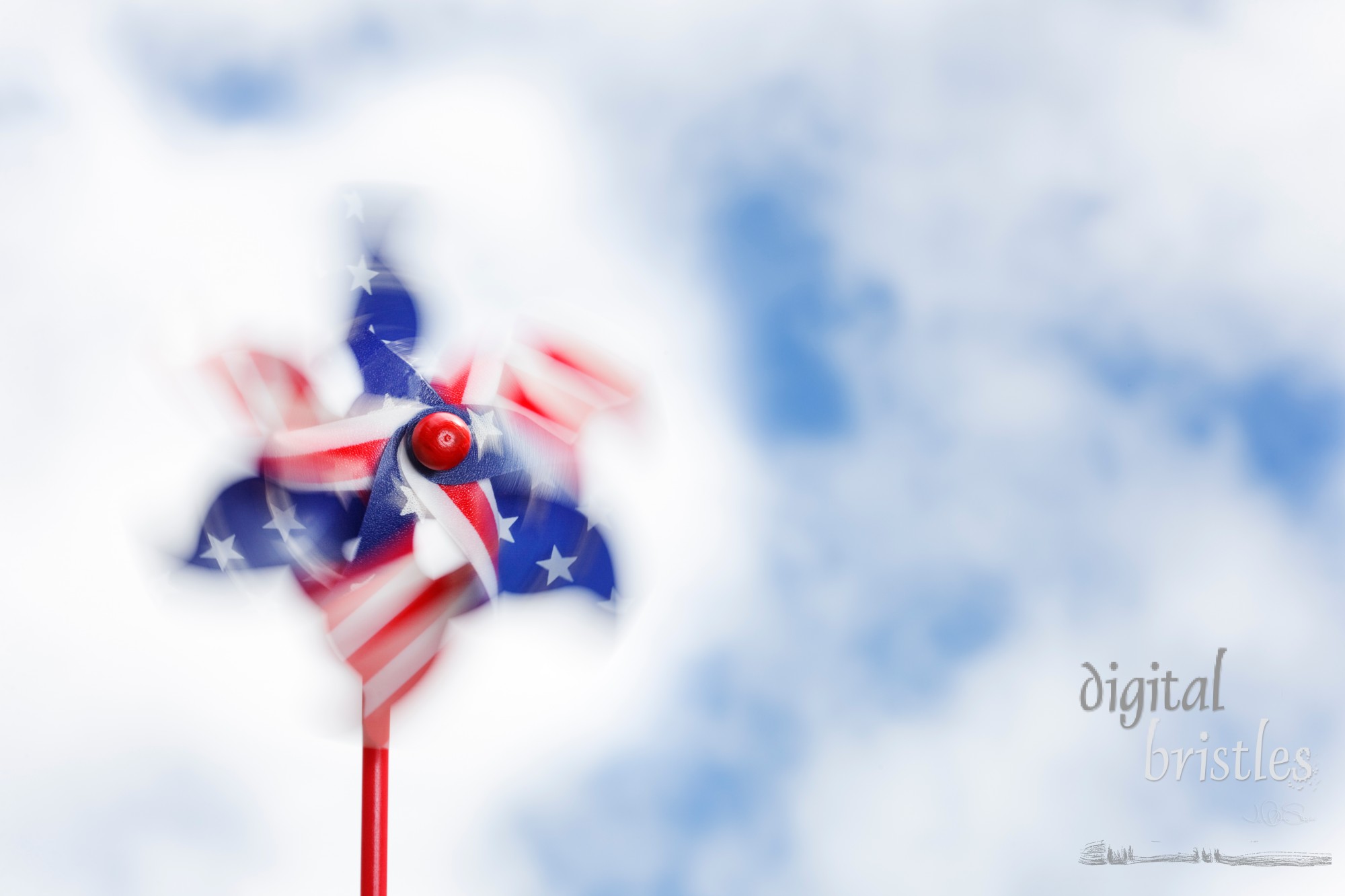 Swirls of motion blur in a spinning stars & stripes pinwheel