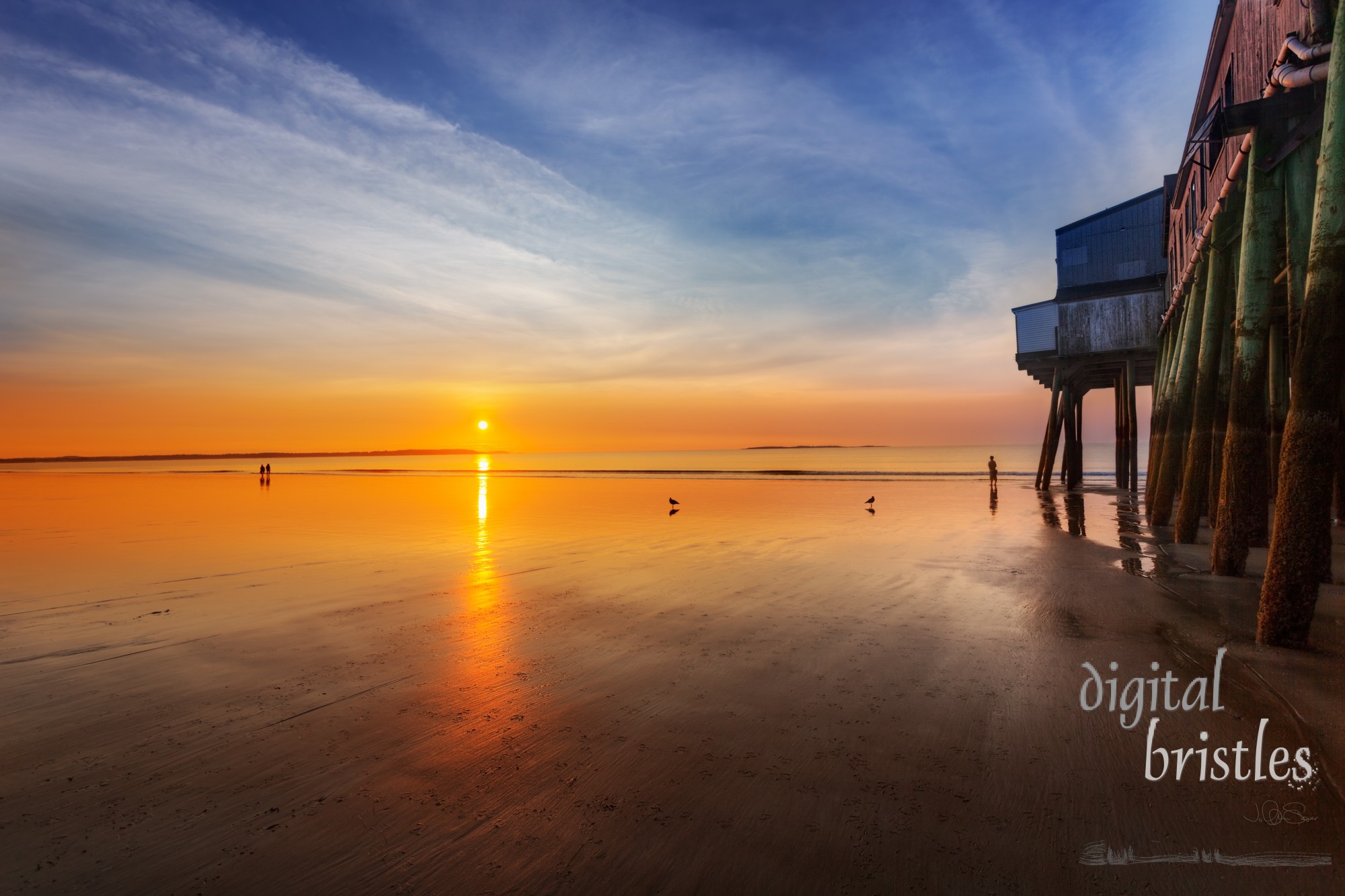 Sun rises and lights the Old Orchard Beach, Maine, pier