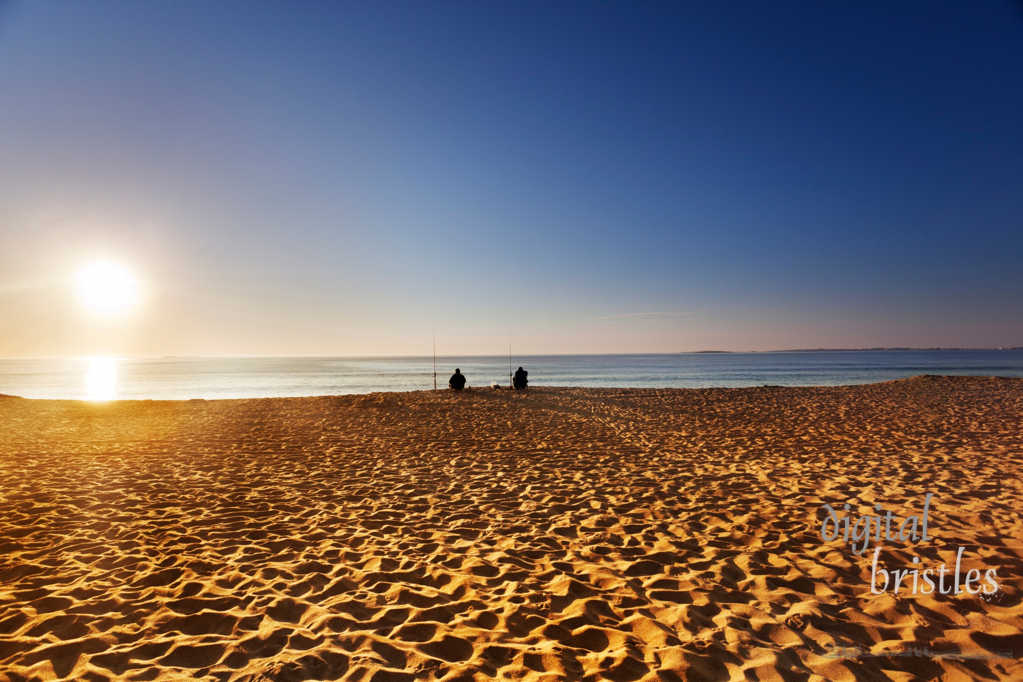 Sun comes over the horizon on a Maine beach in summer