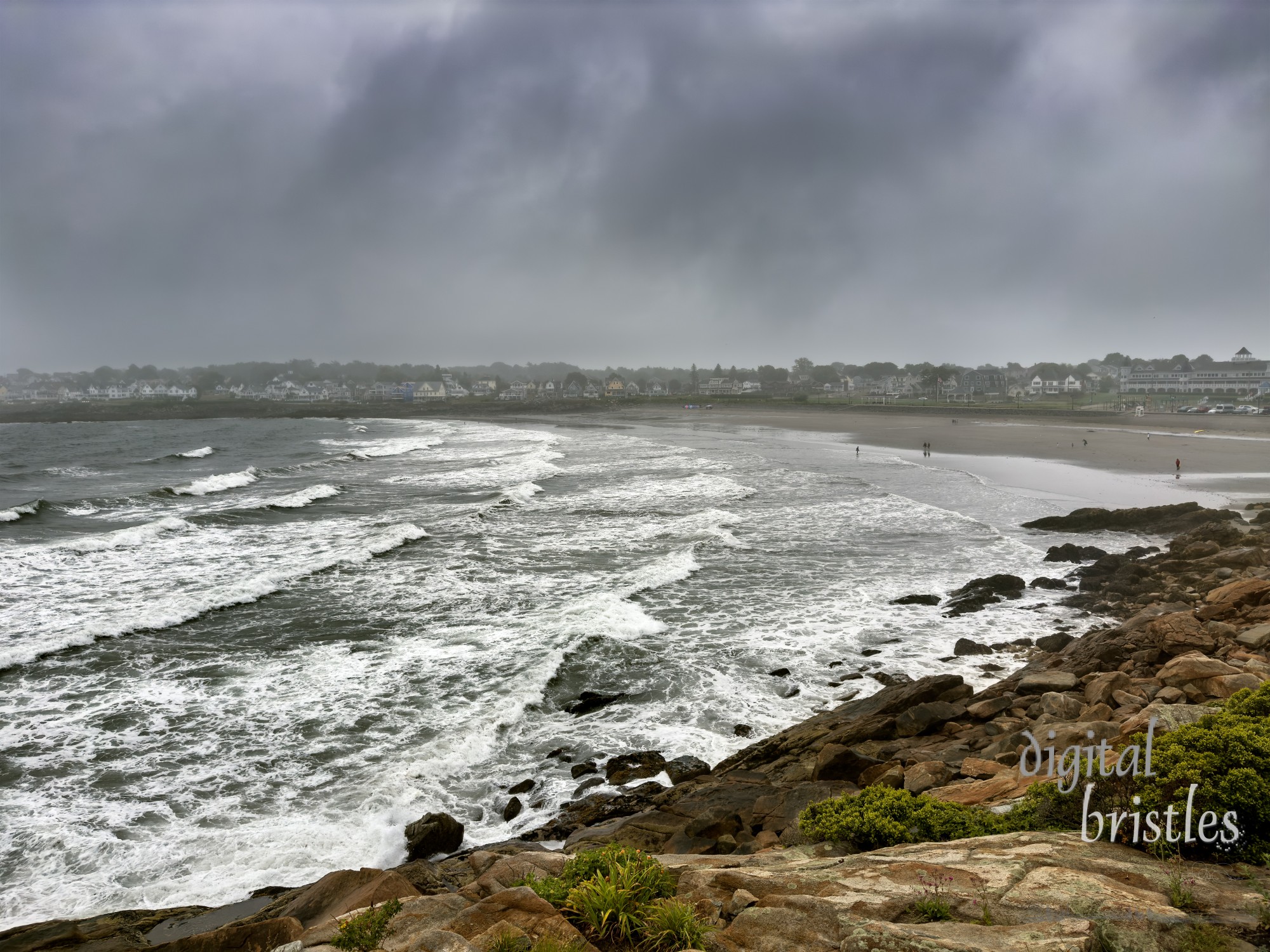 Even on a stormy summer morning, a handful of people explore the beach, Short Sands, York, Maine