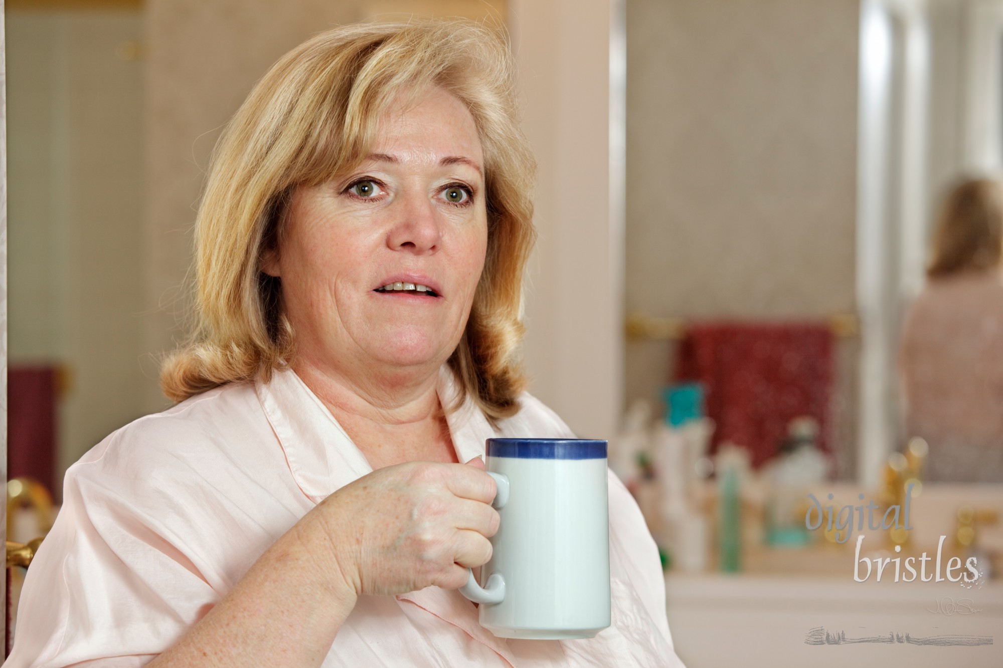 Mature woman's morning routine - trying to wake up with a mug of coffee