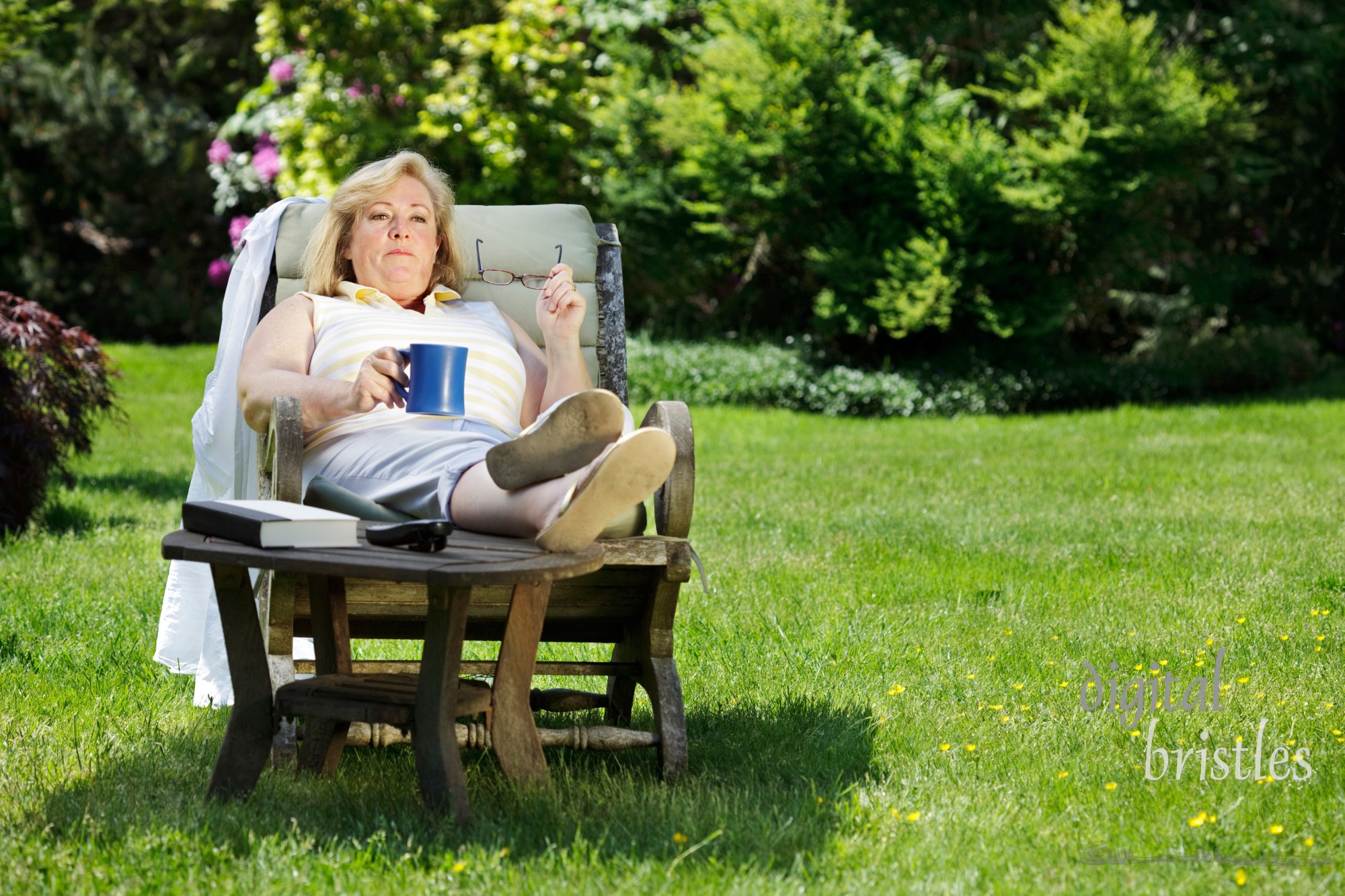 Mature woman has a coffee/tea break outside on a sunny Spring morning