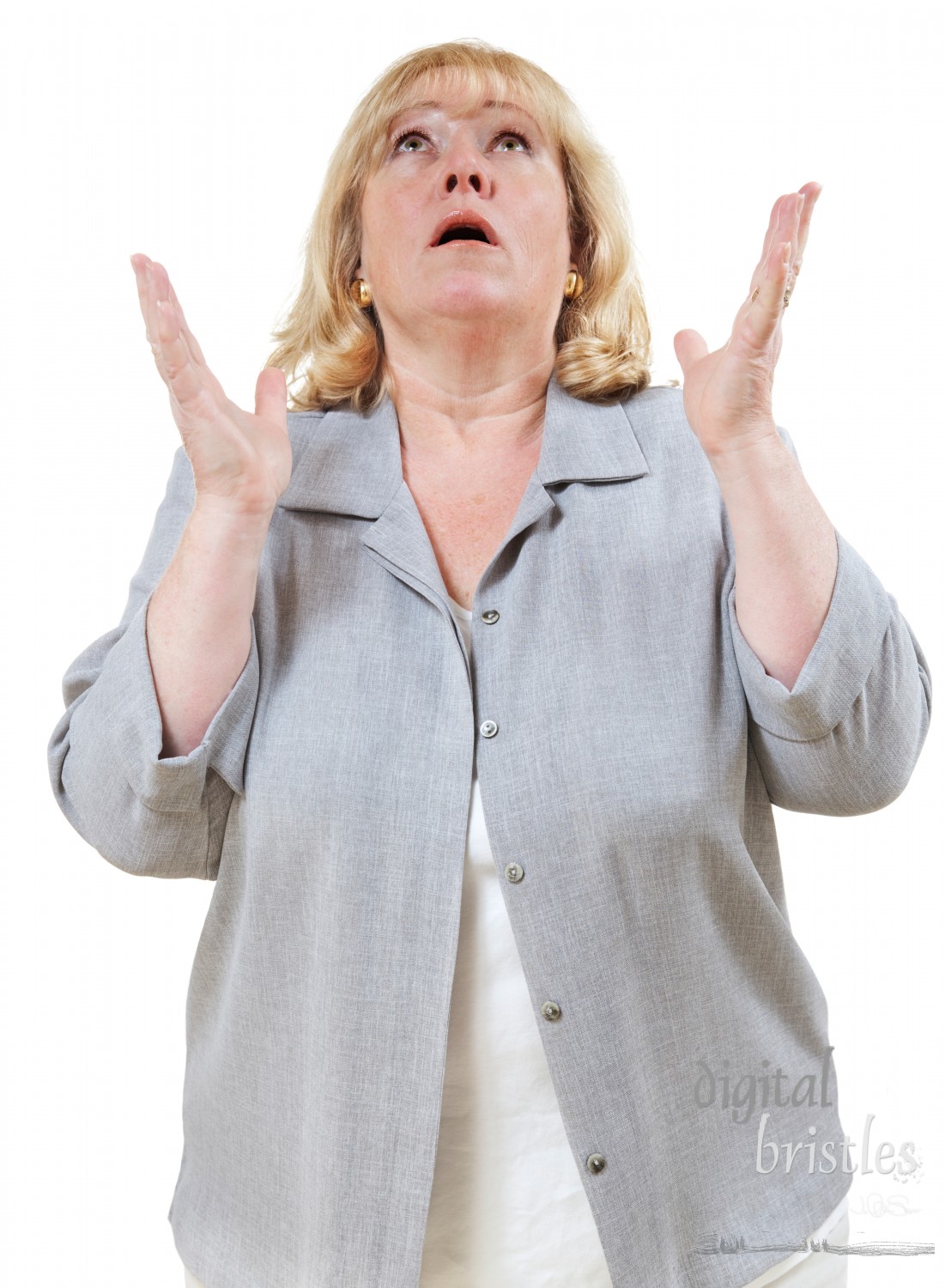 Mature woman looks up with hands raised