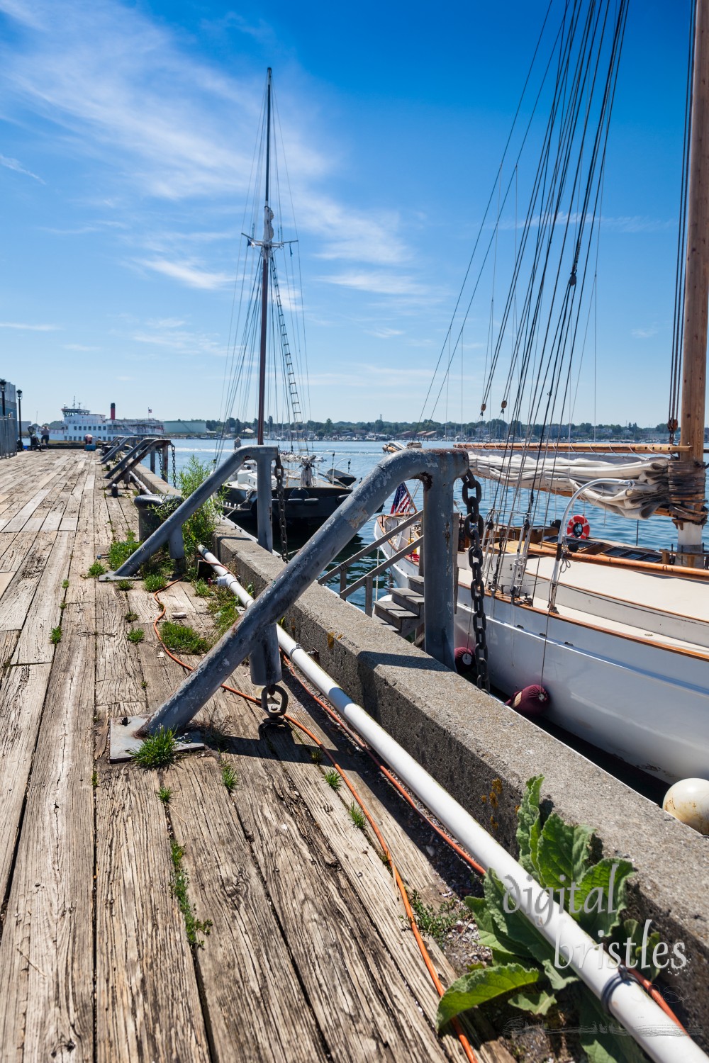 Sailboats docked as Casco Bay ferry rounds the end of the pier, Portland, Maine