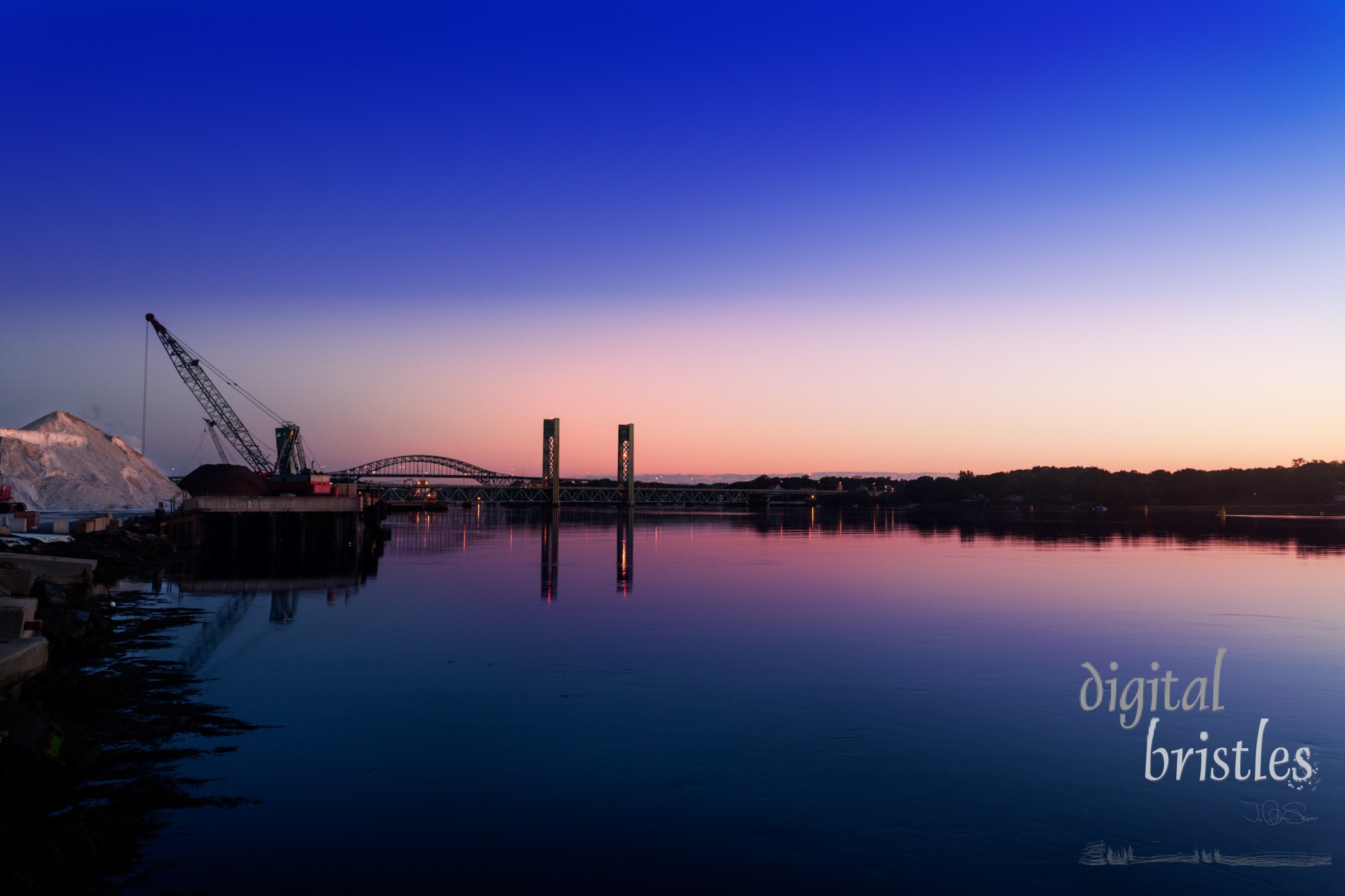 Pre-sunrise light over the Piscataqua River, bridges to Kittery, Maine,  and the huge salt pile (for winter de-icing), Portsmouth, New Hampshire