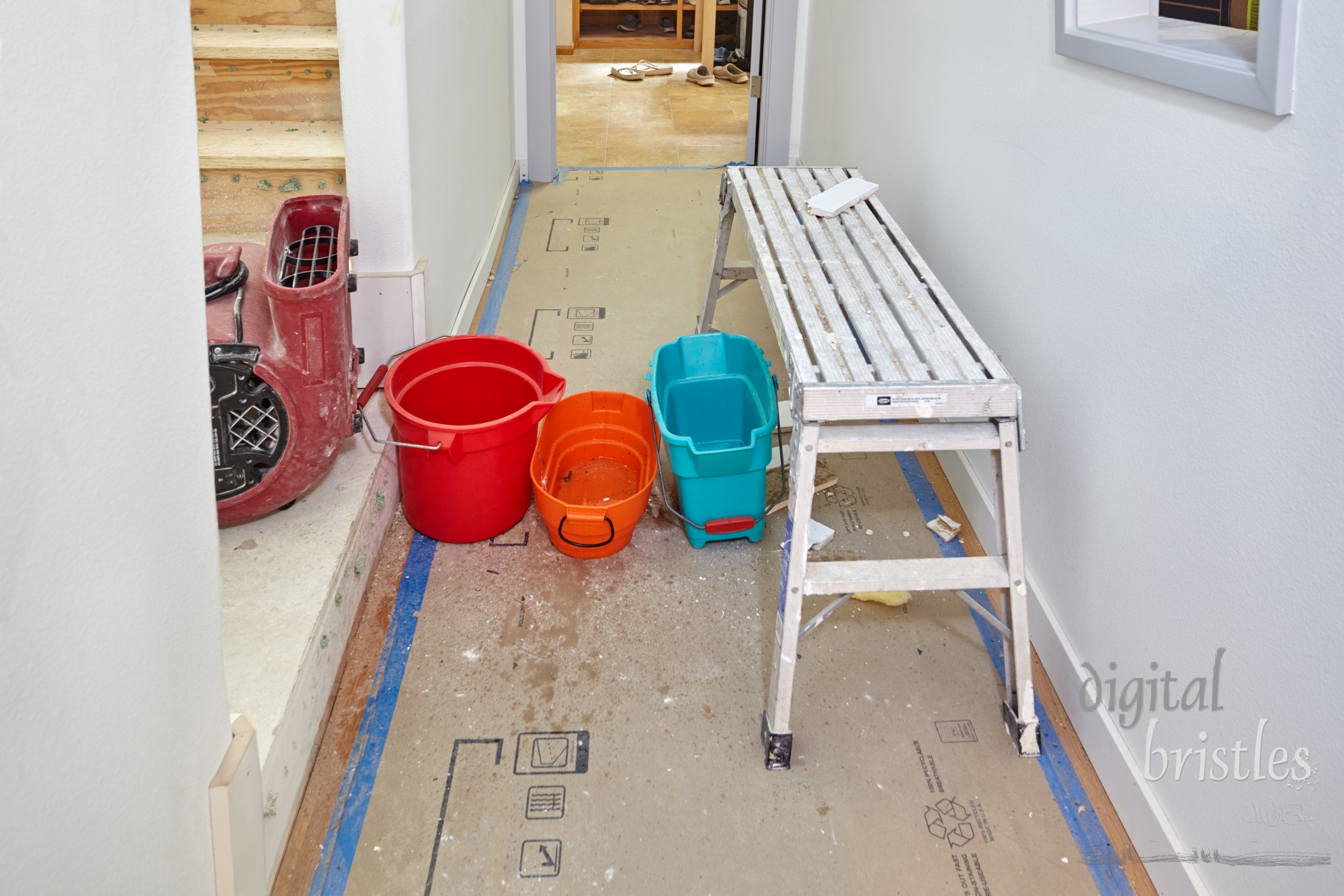 Water leak through ceiling dripping into buckets and onto floor