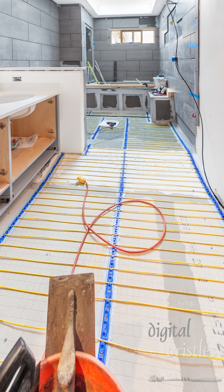 Electrical wiring for under floor electric heating being installed in a residential bathroom