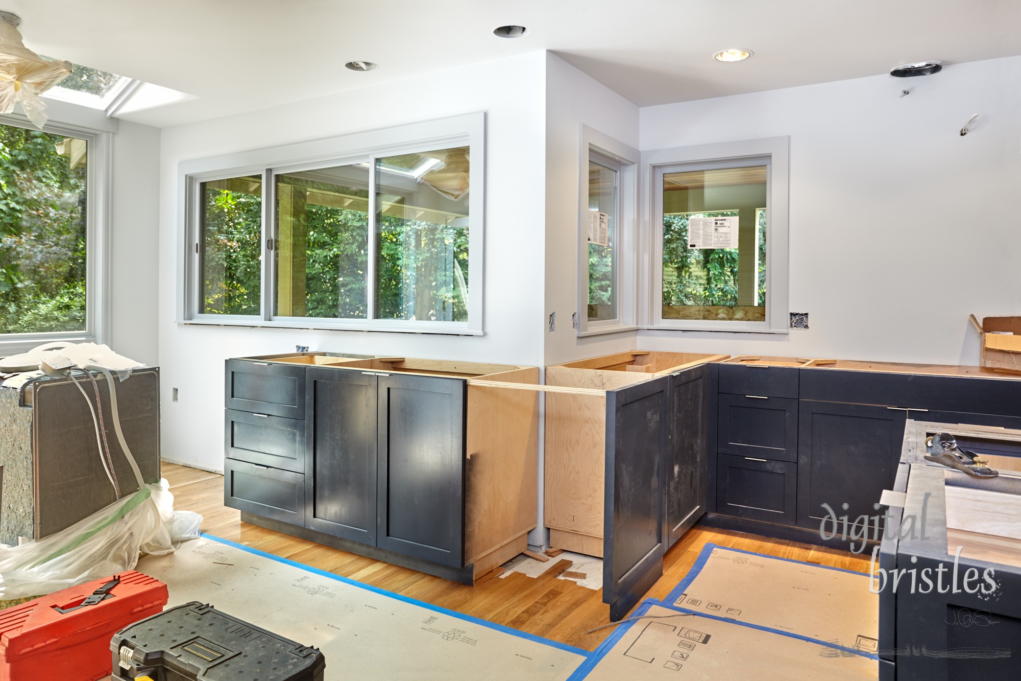 Kitchen cabinet installation continues, with island complete, ready for countertop template