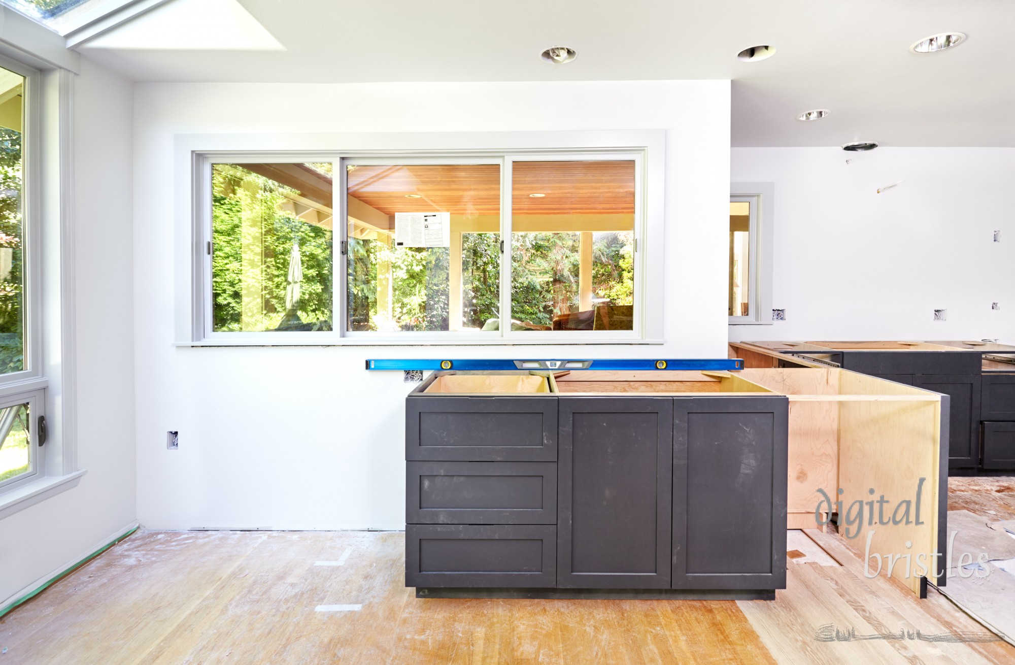 Custom kitchen cabinets placed and leveled.