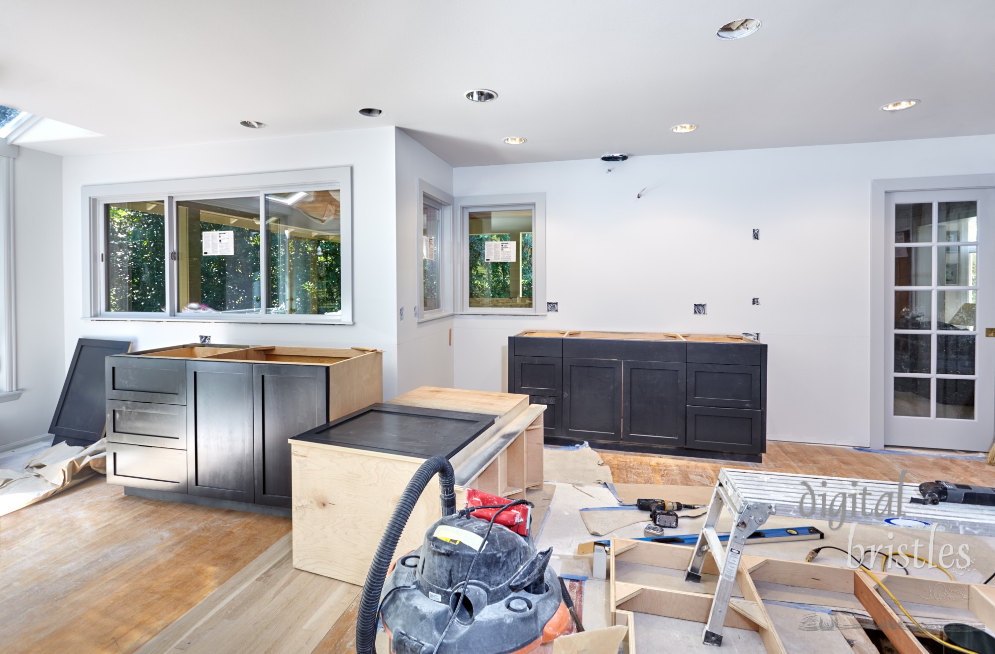 Custom kitchen cabinets arranged in place in remodeled kitchen. Corner cabinet lying on its back.