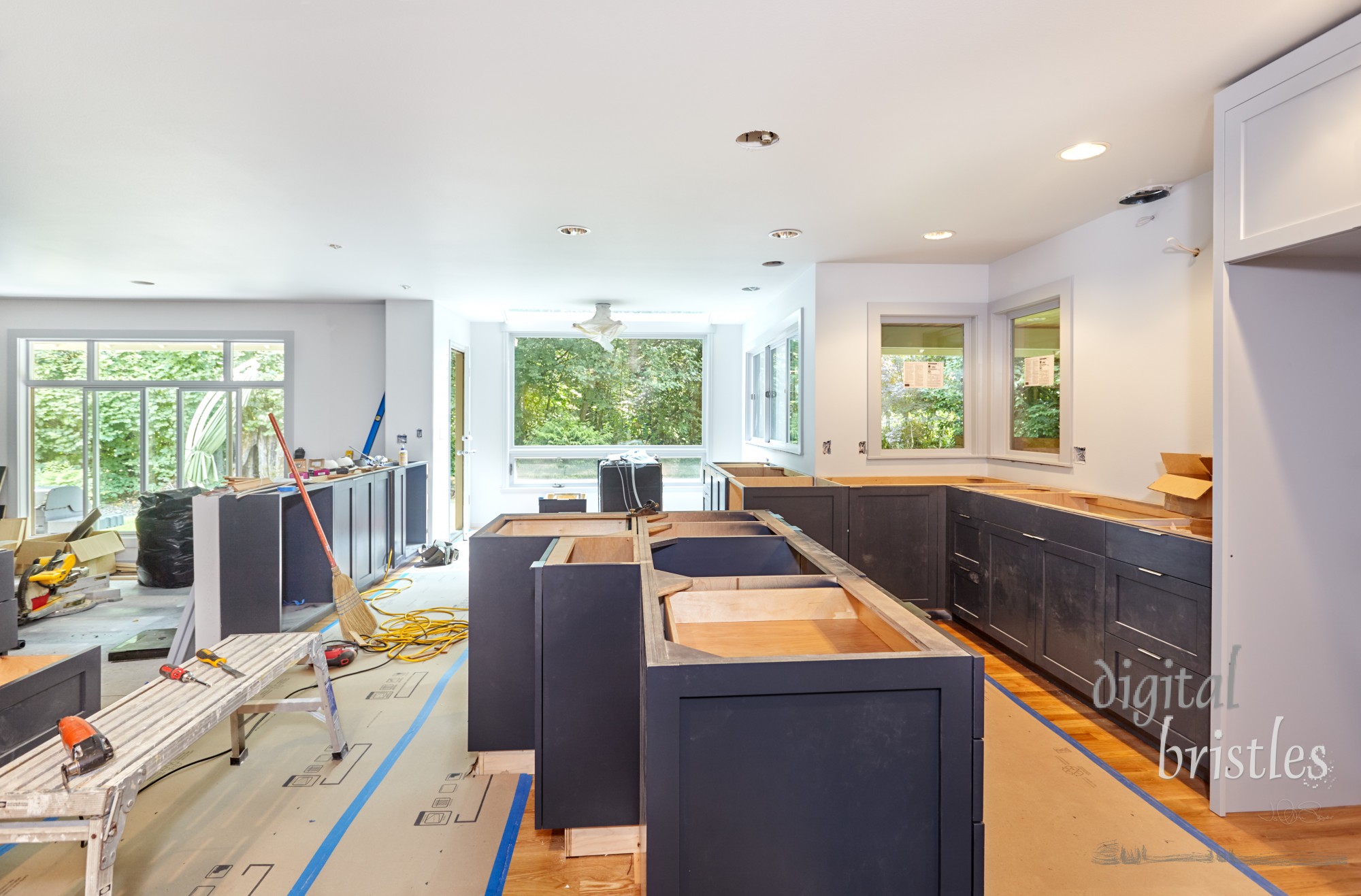 Installation of custom kitchen cabinets and island in progress