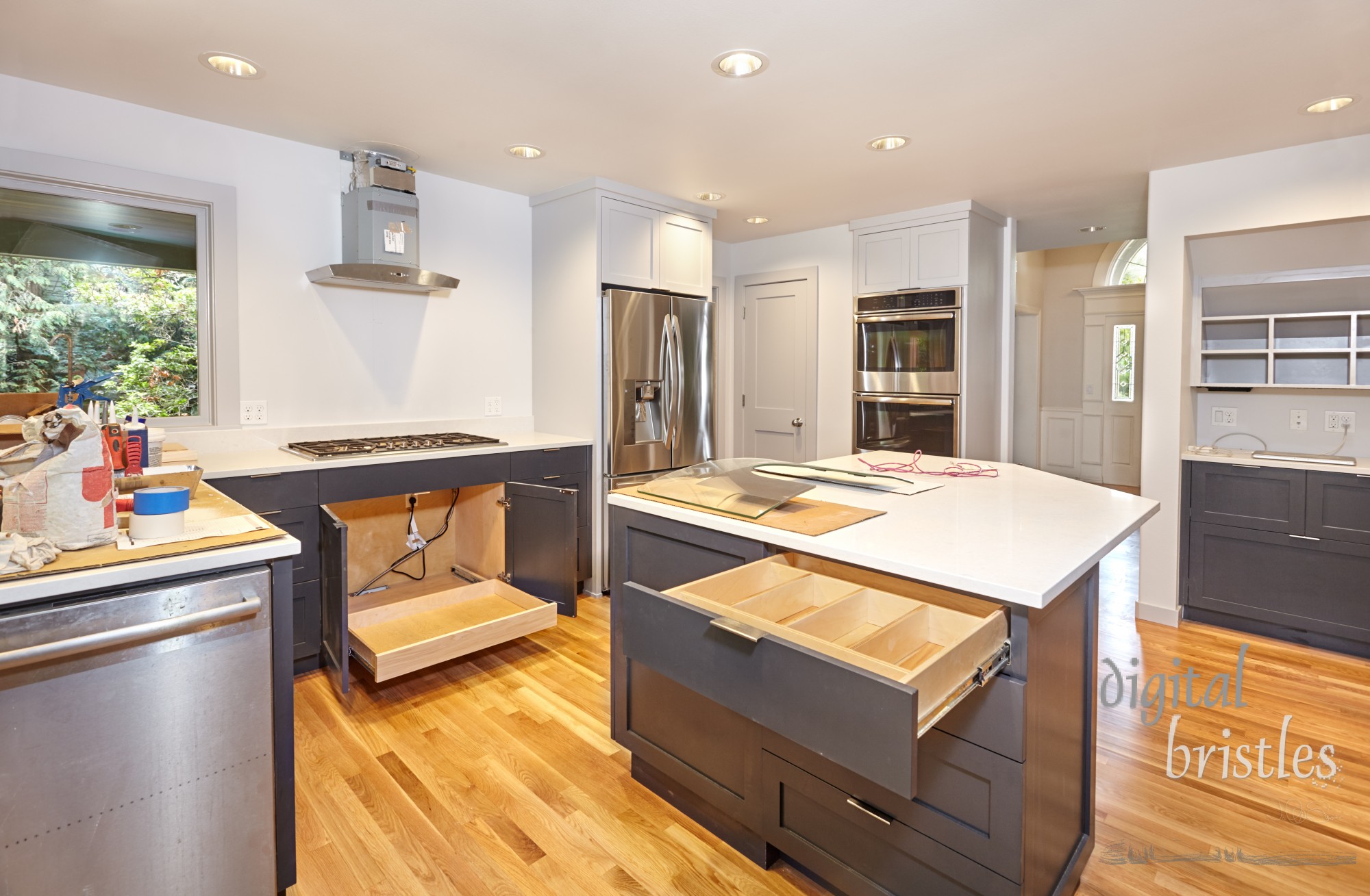 Drawer inserts and pullout tray installed in custom kitchen cabinets during kitchen remodel