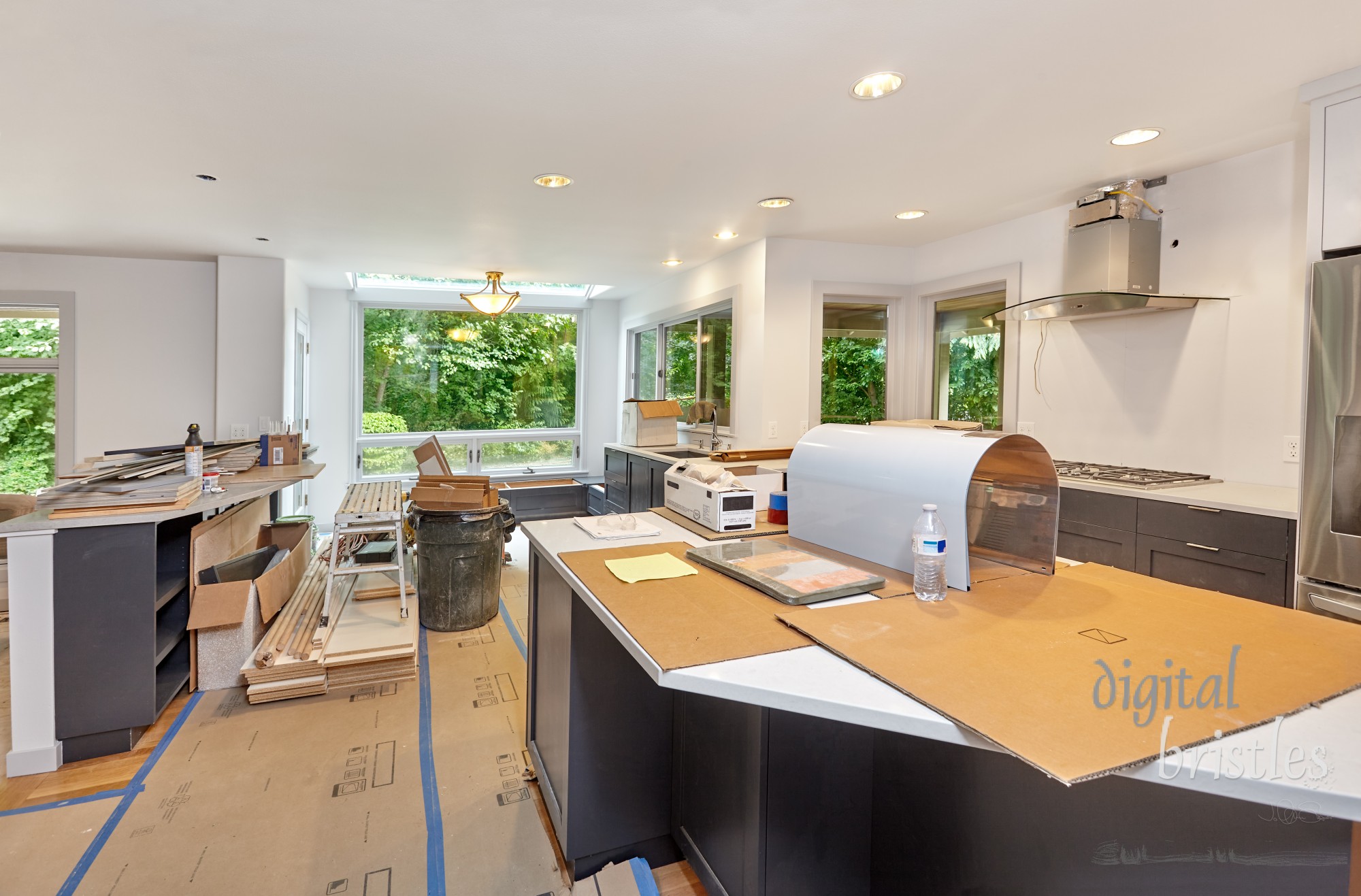 Kitchen remodel with tools and supplies cleaned up. Appliances and countertops in place; custom cabinets, island and window seats nearly complete.