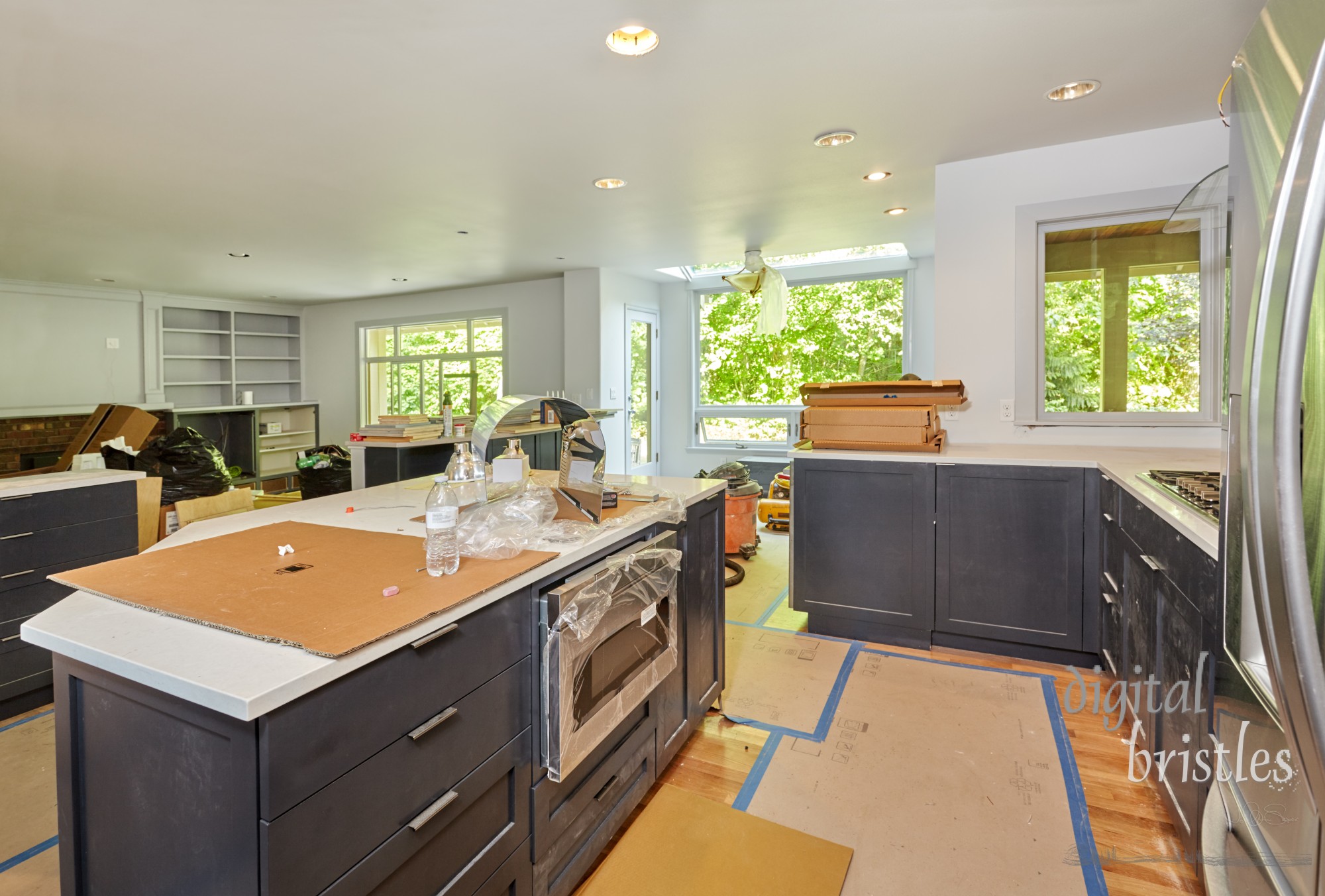 Partially finished kitchen remodel is a mess of boxes, plastic bags, tools and trash