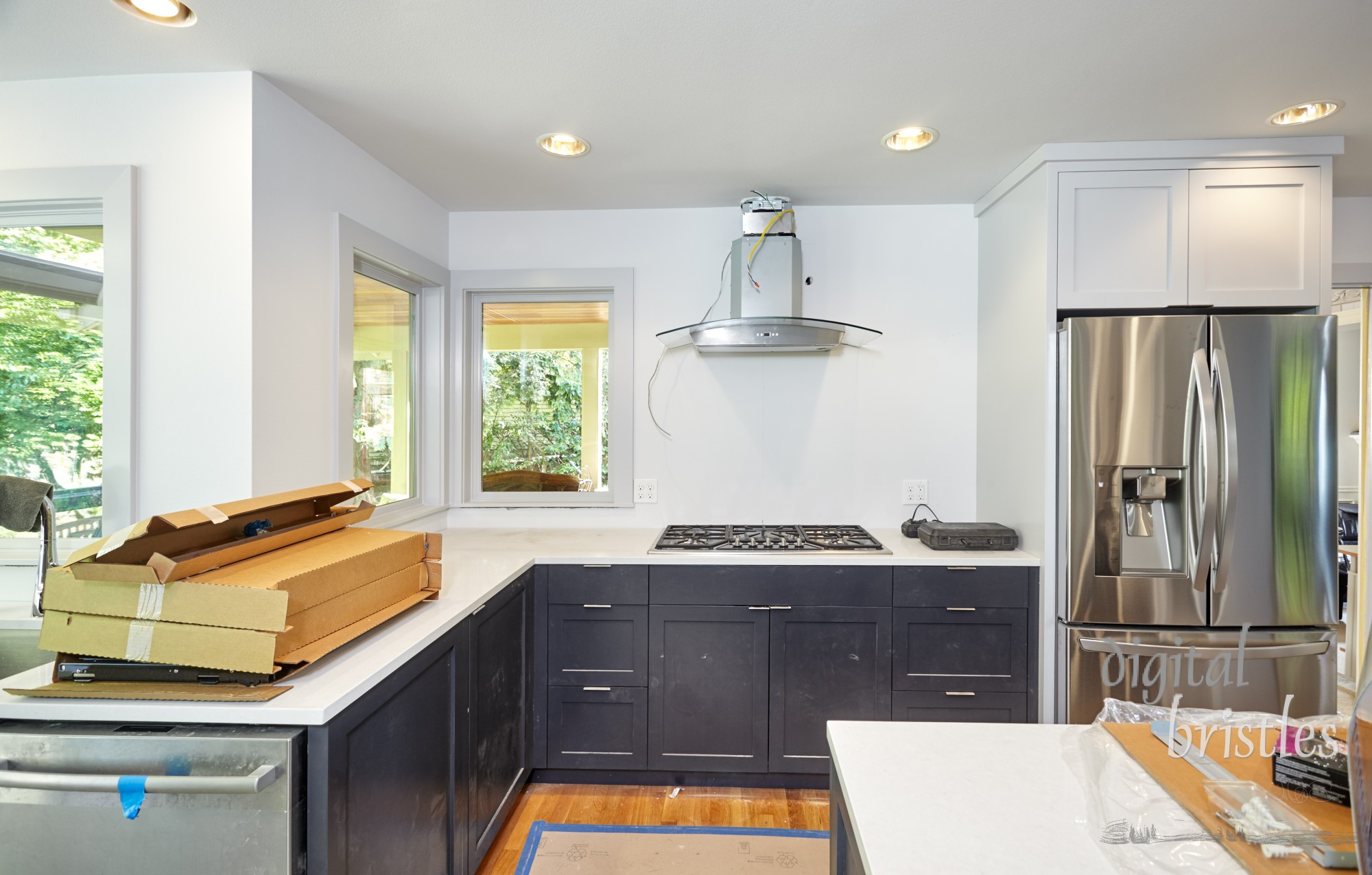 Gas cooktop and range hood motor partially installed