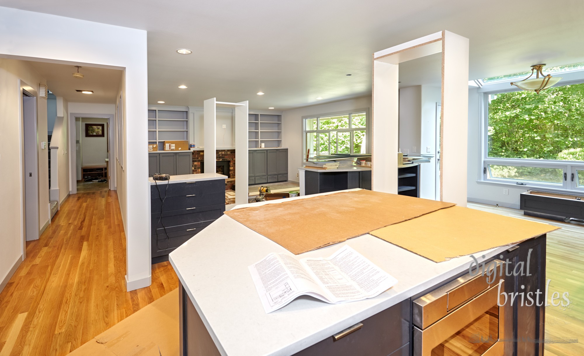 Kitchen temporarily housing shelf frames for another room as cabinet and shelving installation nears completion