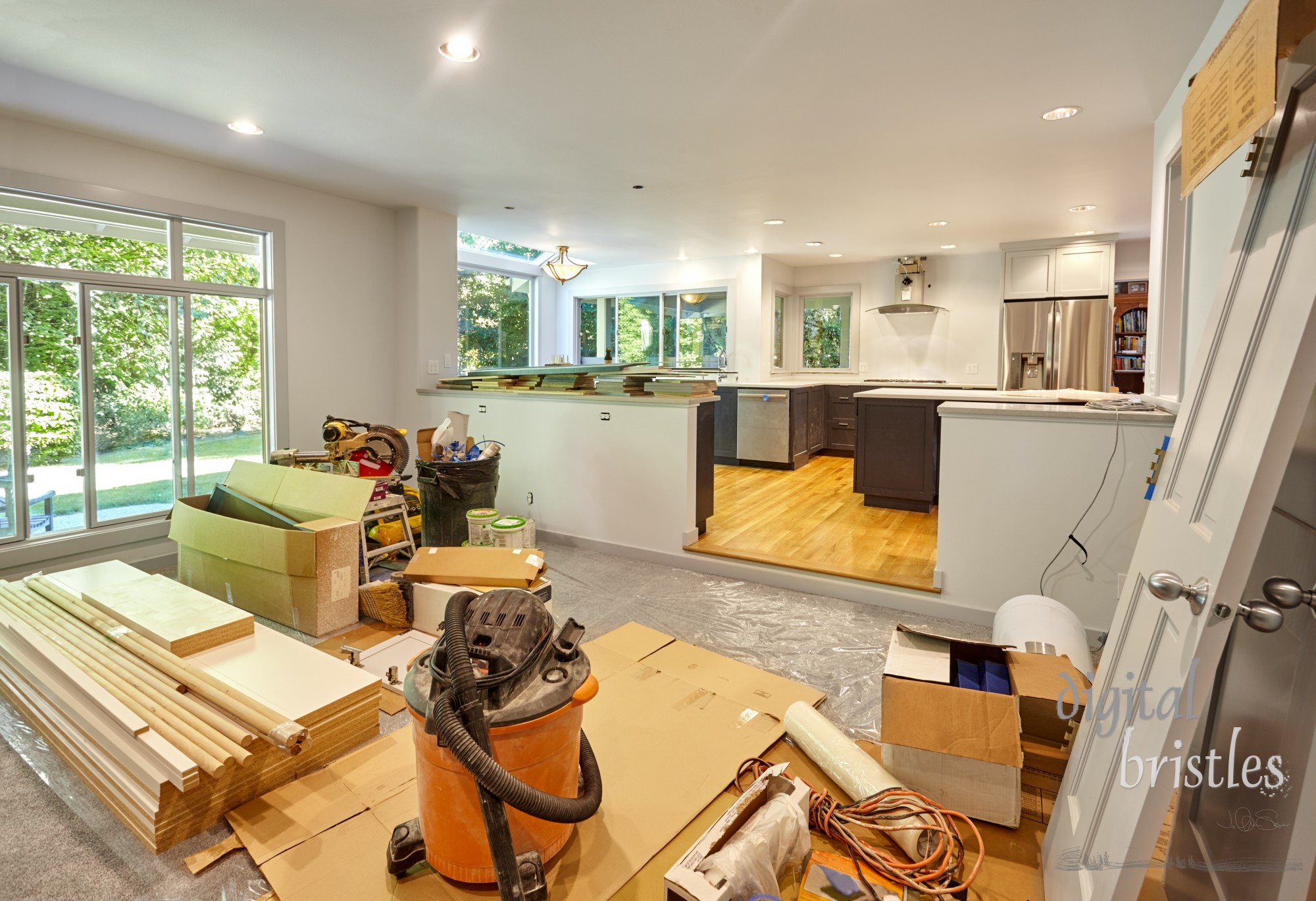 Shelves, circular saw, doors and other remodeling tools and supplies fill the family room as the kitchen is worked on