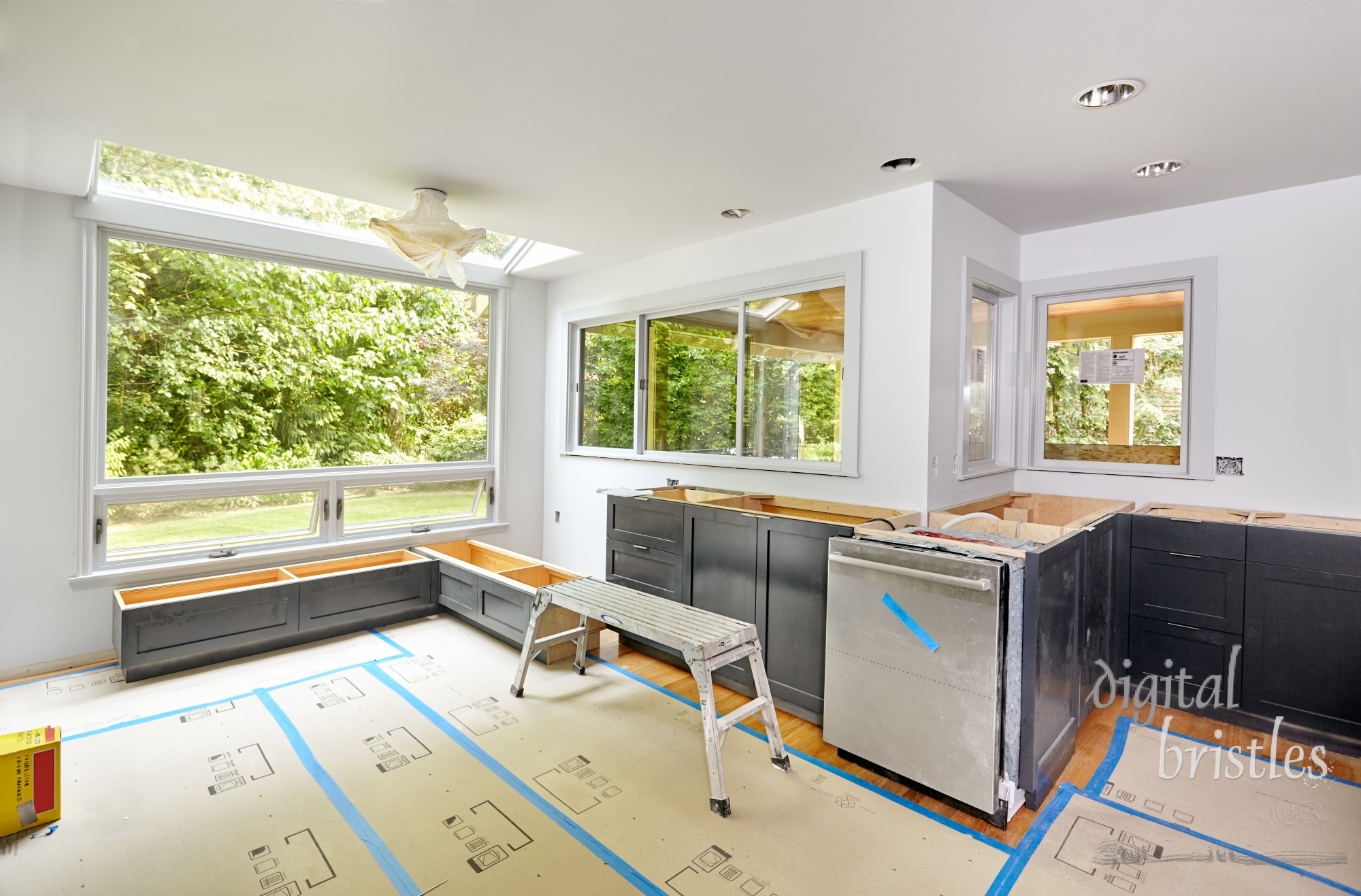 Beginning to install storage cabinets under window seats in the kitchen eating nook