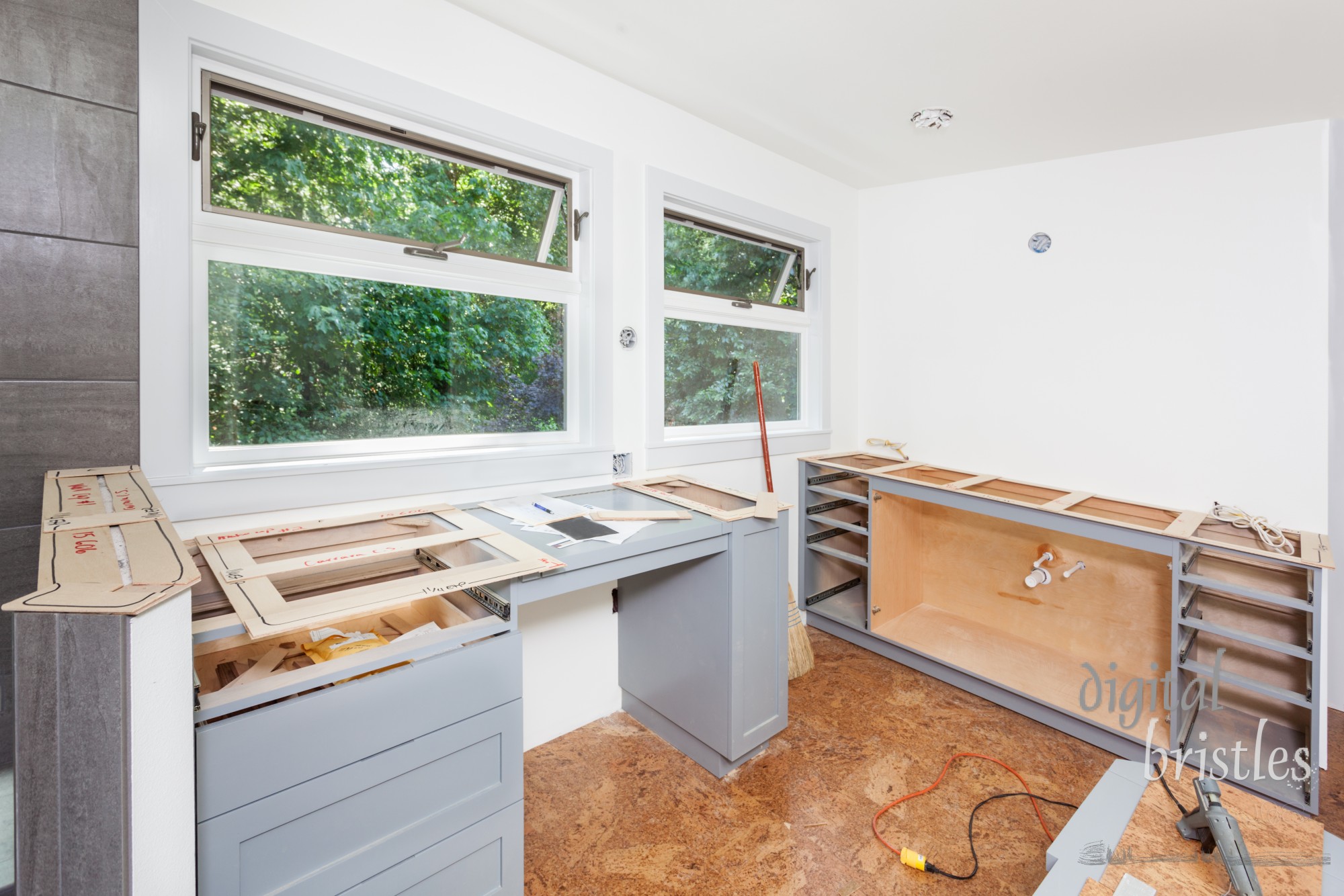 Balsa wood template for engineered stone countertops laid over cabinet tops