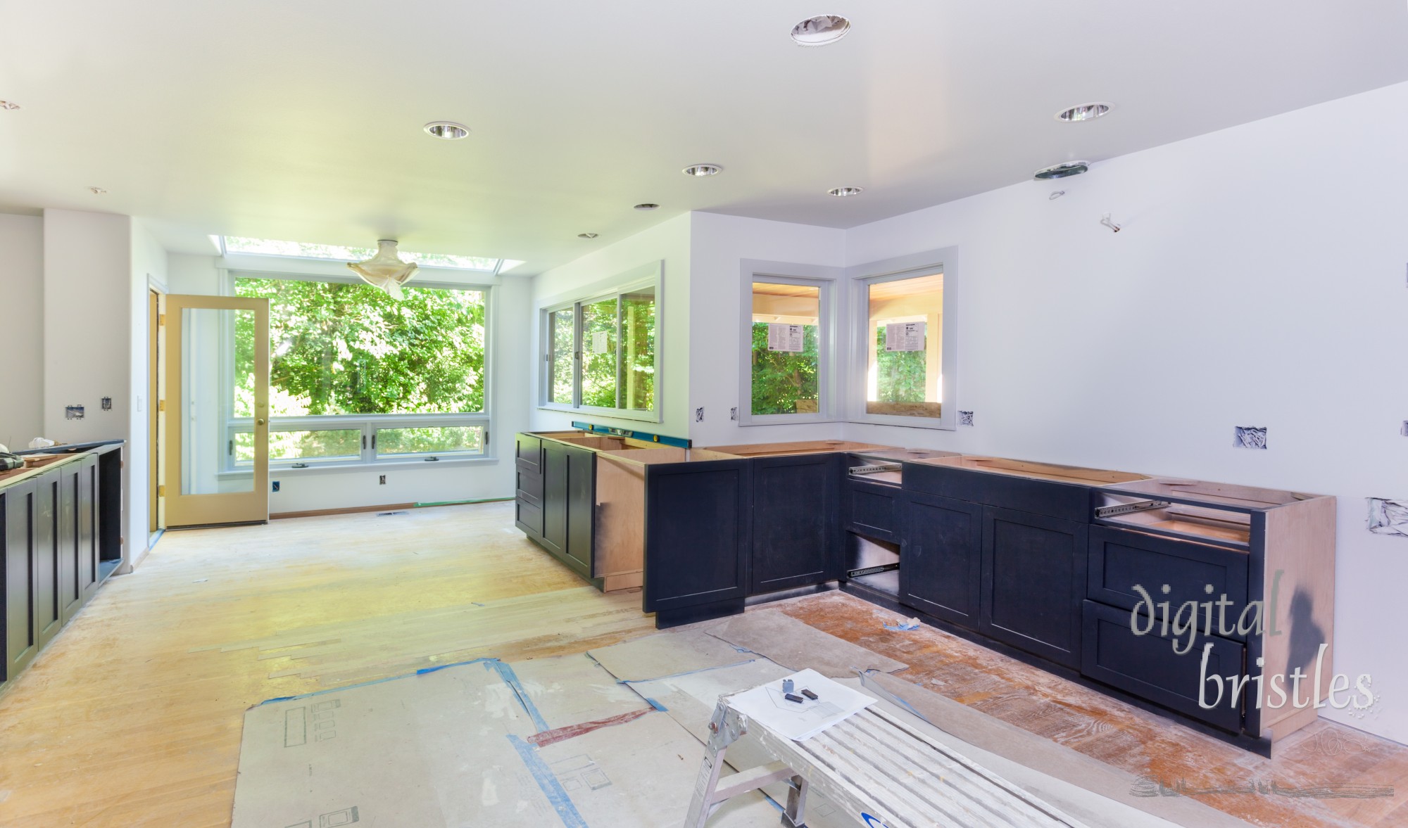 Custom kitchen cabinets arranged and installed. Hardwood floor patched.