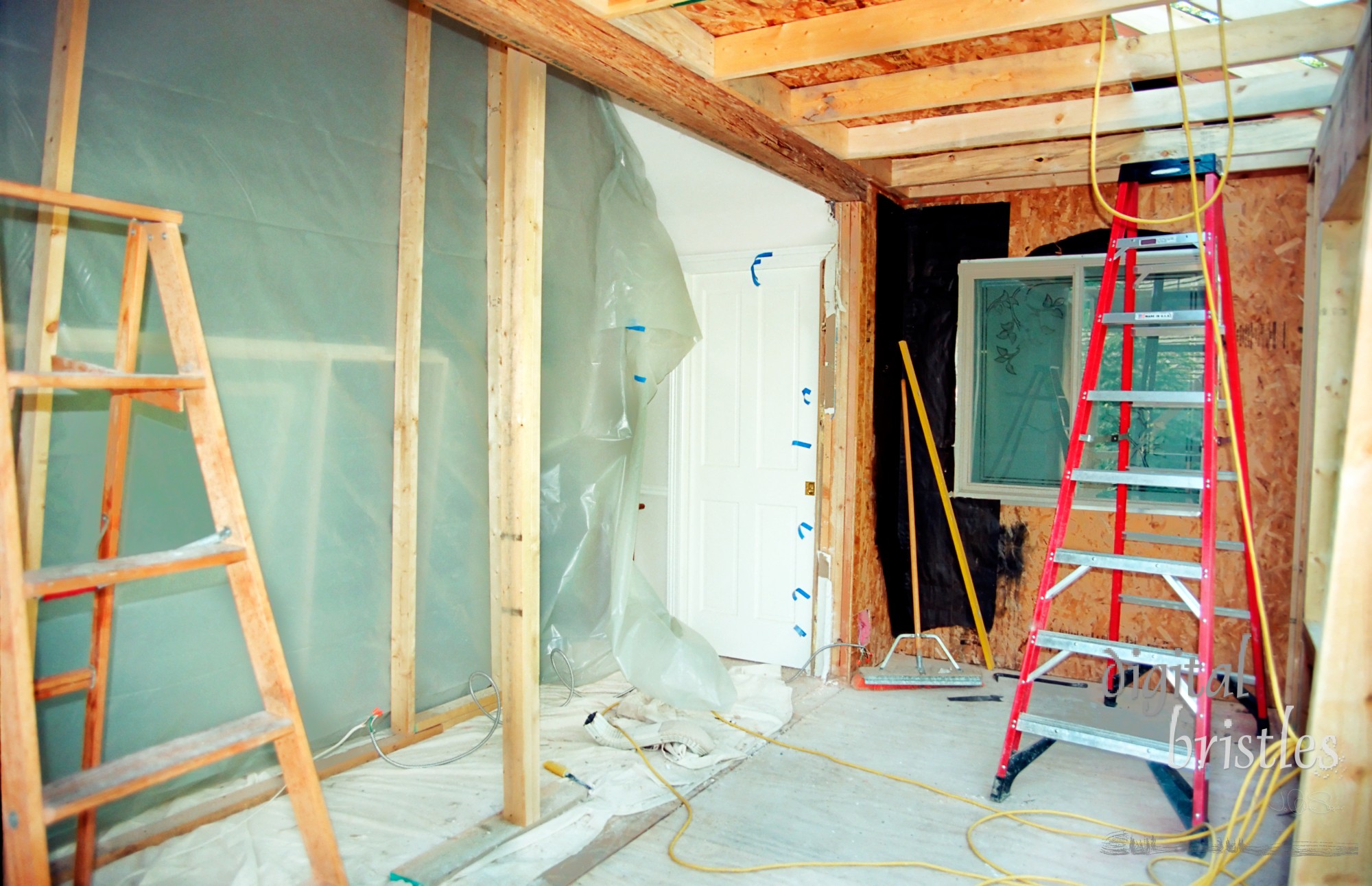 Plastic tarp covers the missing wall as bedroom is extended with a reading area. Roof supports in place.