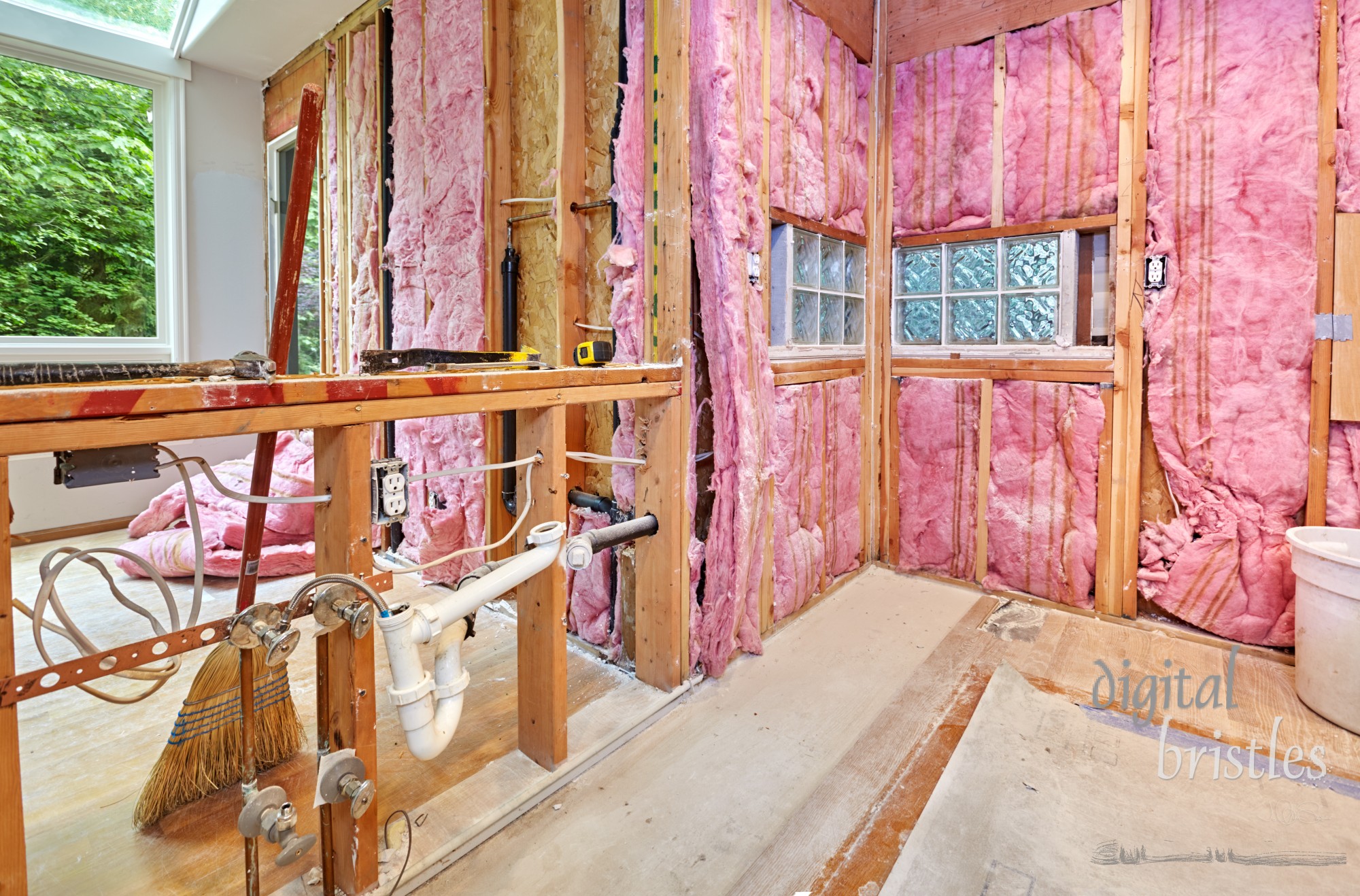 Pipes and wiring from the old counter await relocation to the wall behind them after old kitchen is demolished