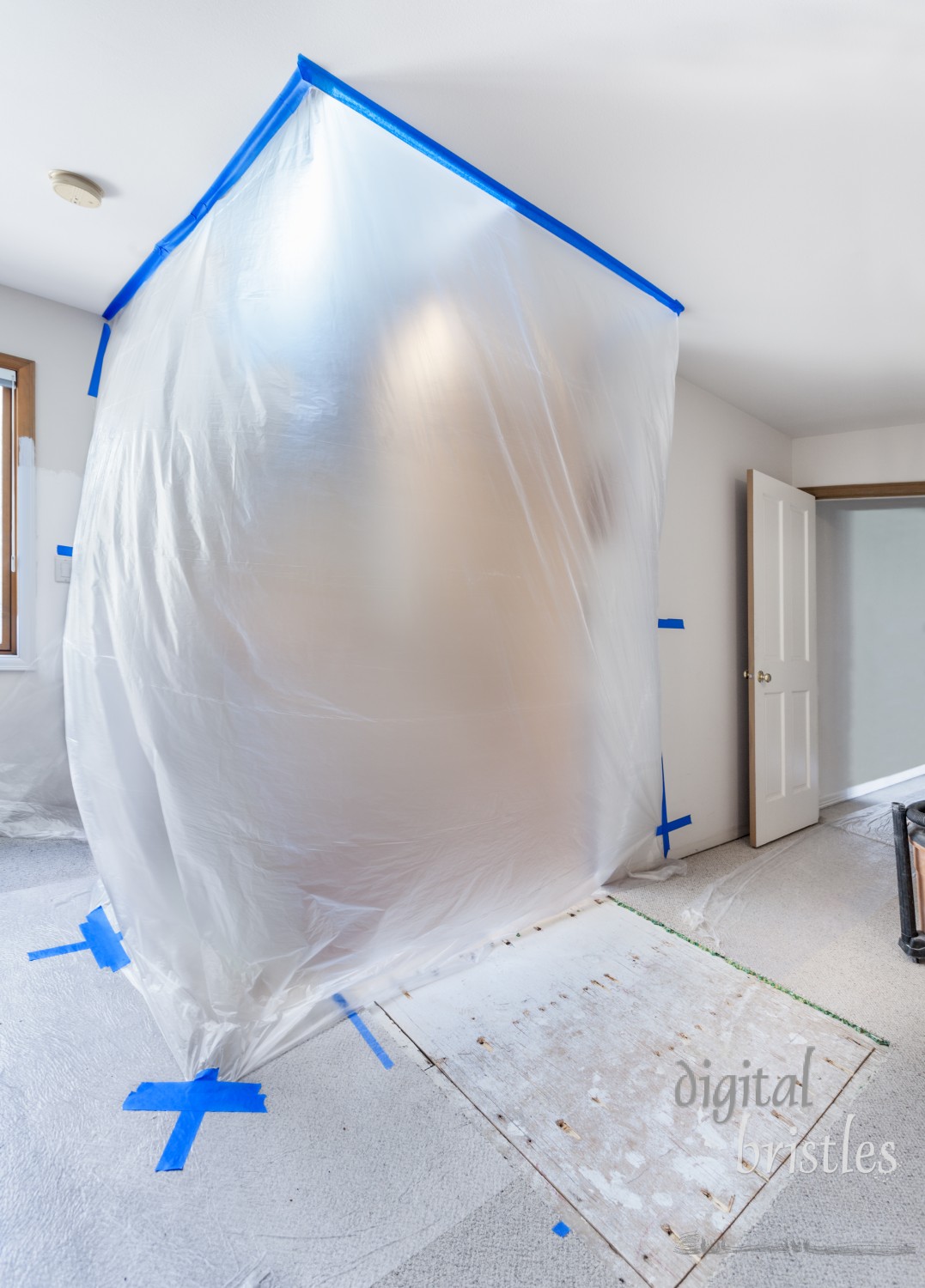 Taped plastic sheeting protects a stairwell during the demolition phase of a home remodel