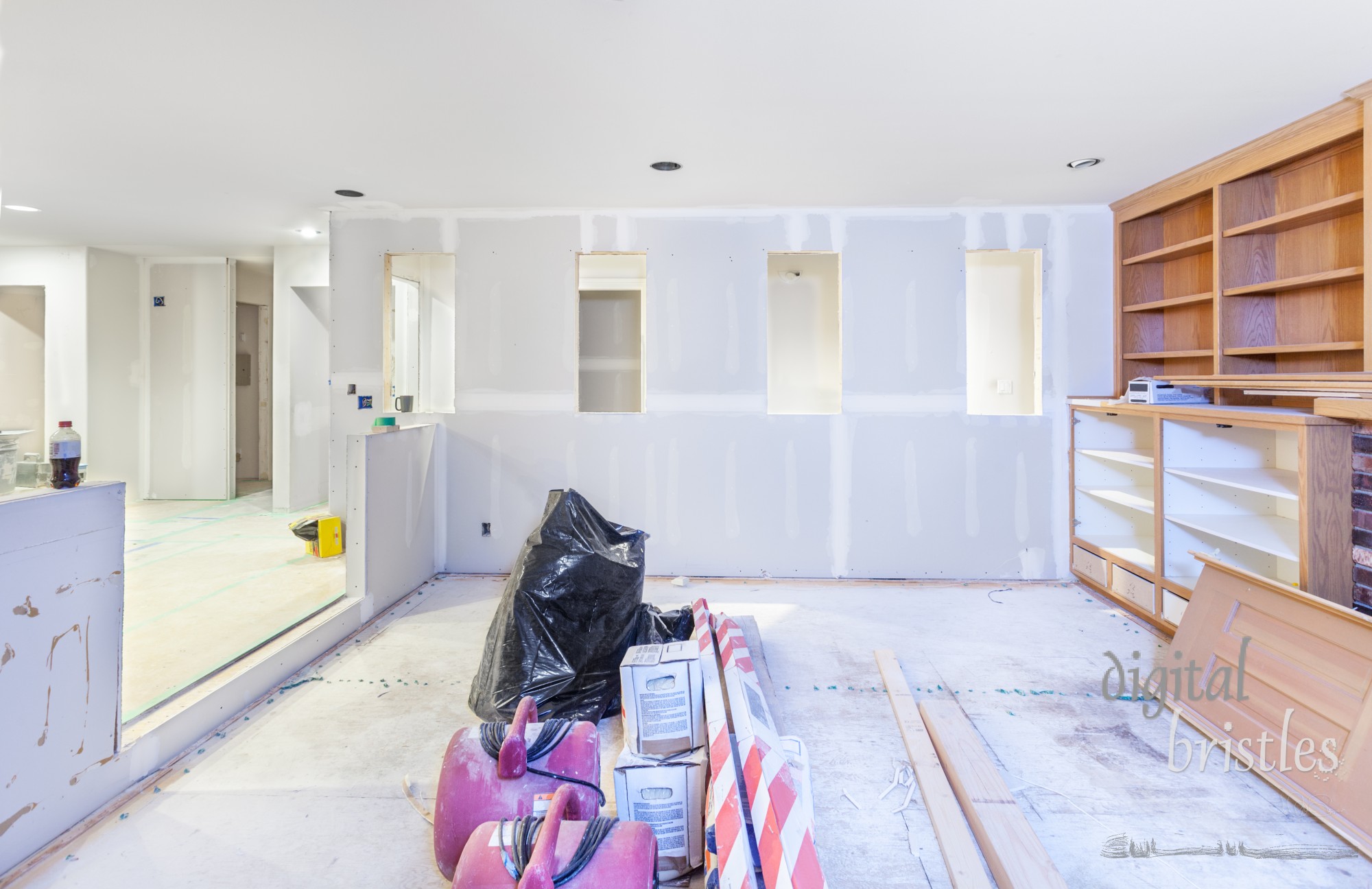 New drywall in the kitchen and family room taped and smoothed with the first coat of spackle (mud)