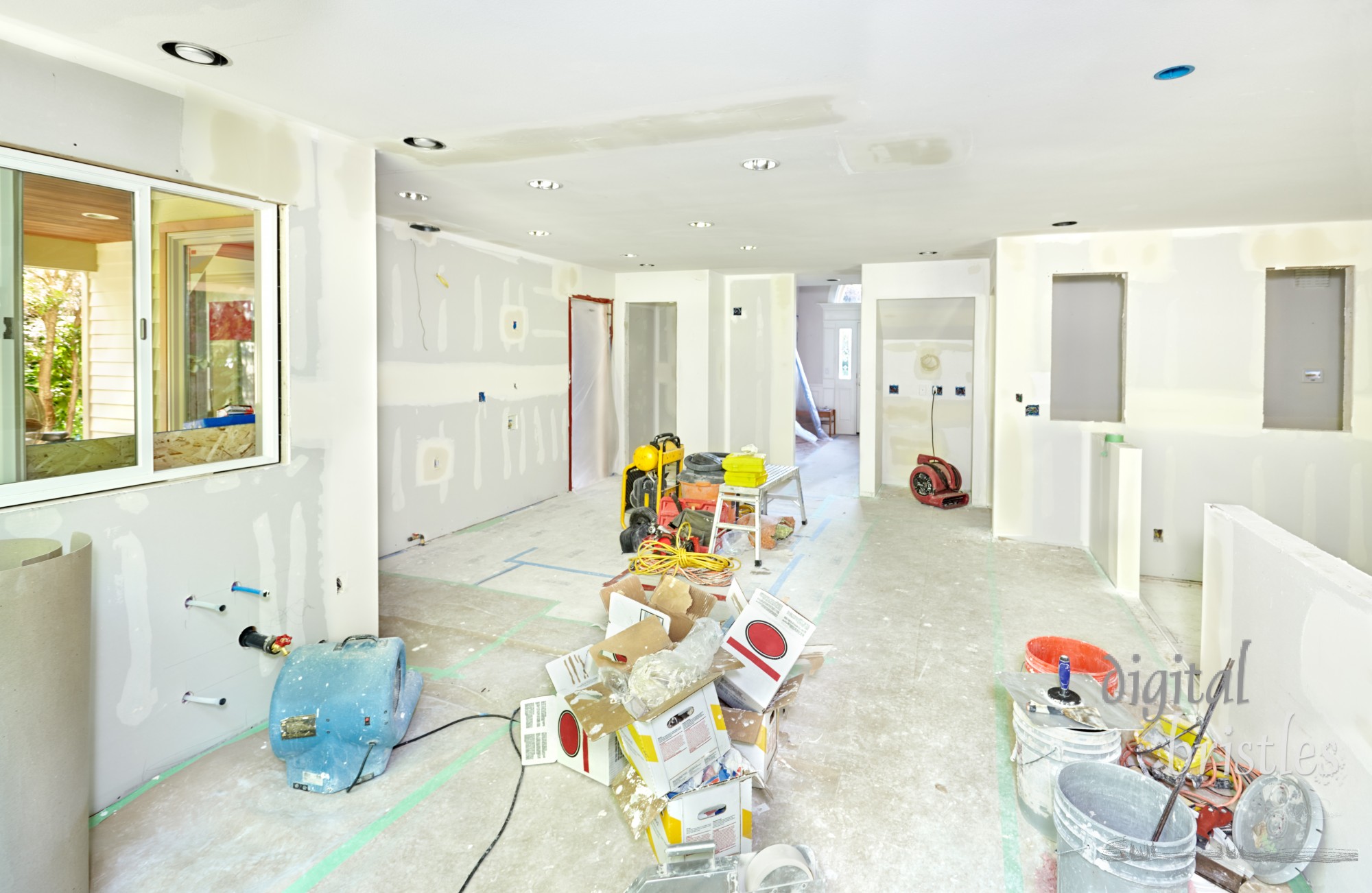 New drywall in the kitchen and family room taped and smoothed with the first coat of spackle (mud)