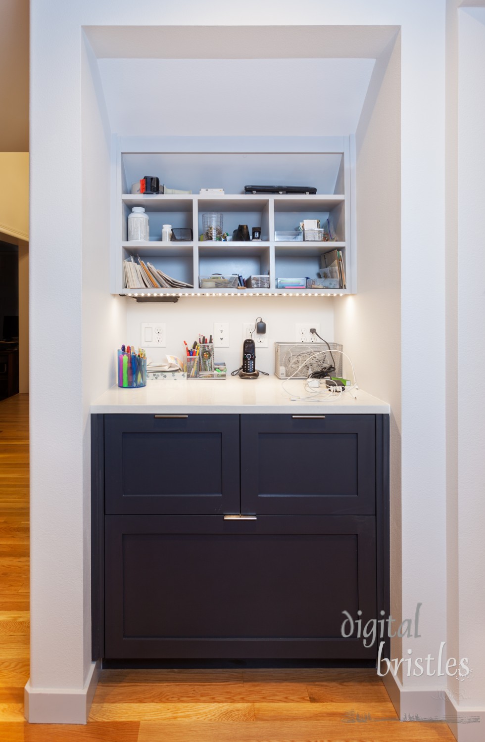 Kitchen desk area with drawers, cubbies and electronics charging station