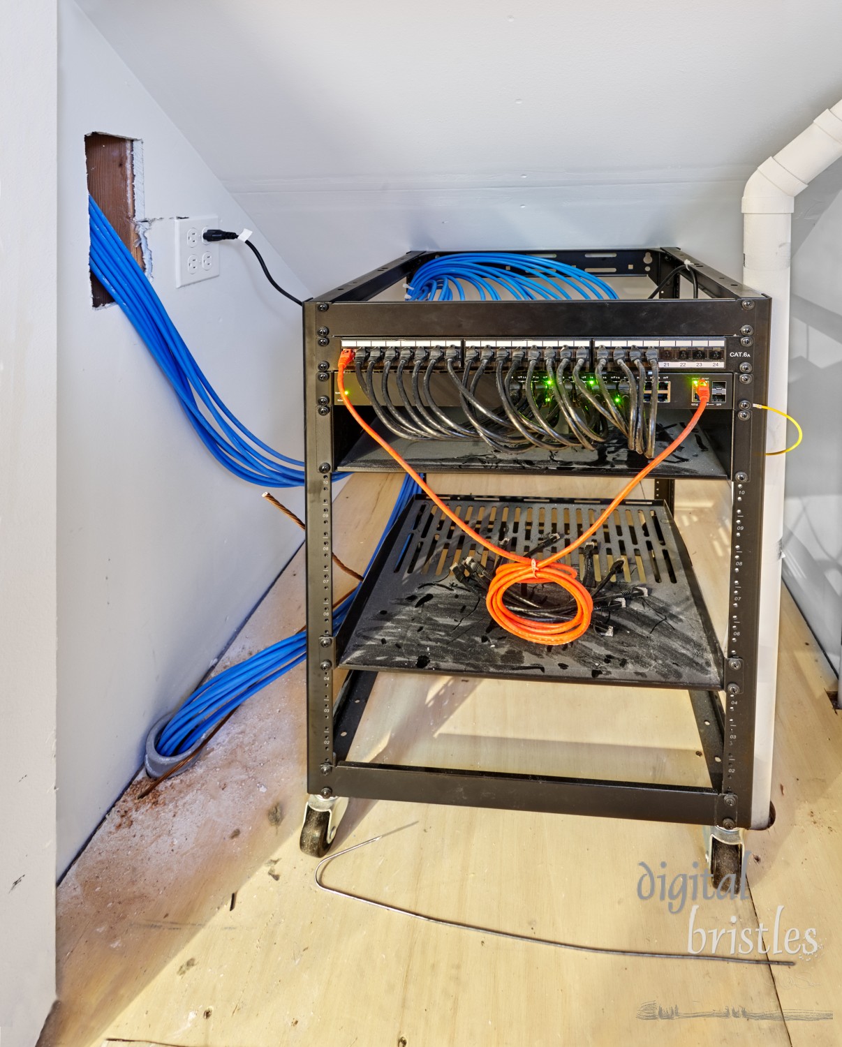 Rack mounted switch connected to network cables routed throughout both levels of the house. Small closet under the stairs.