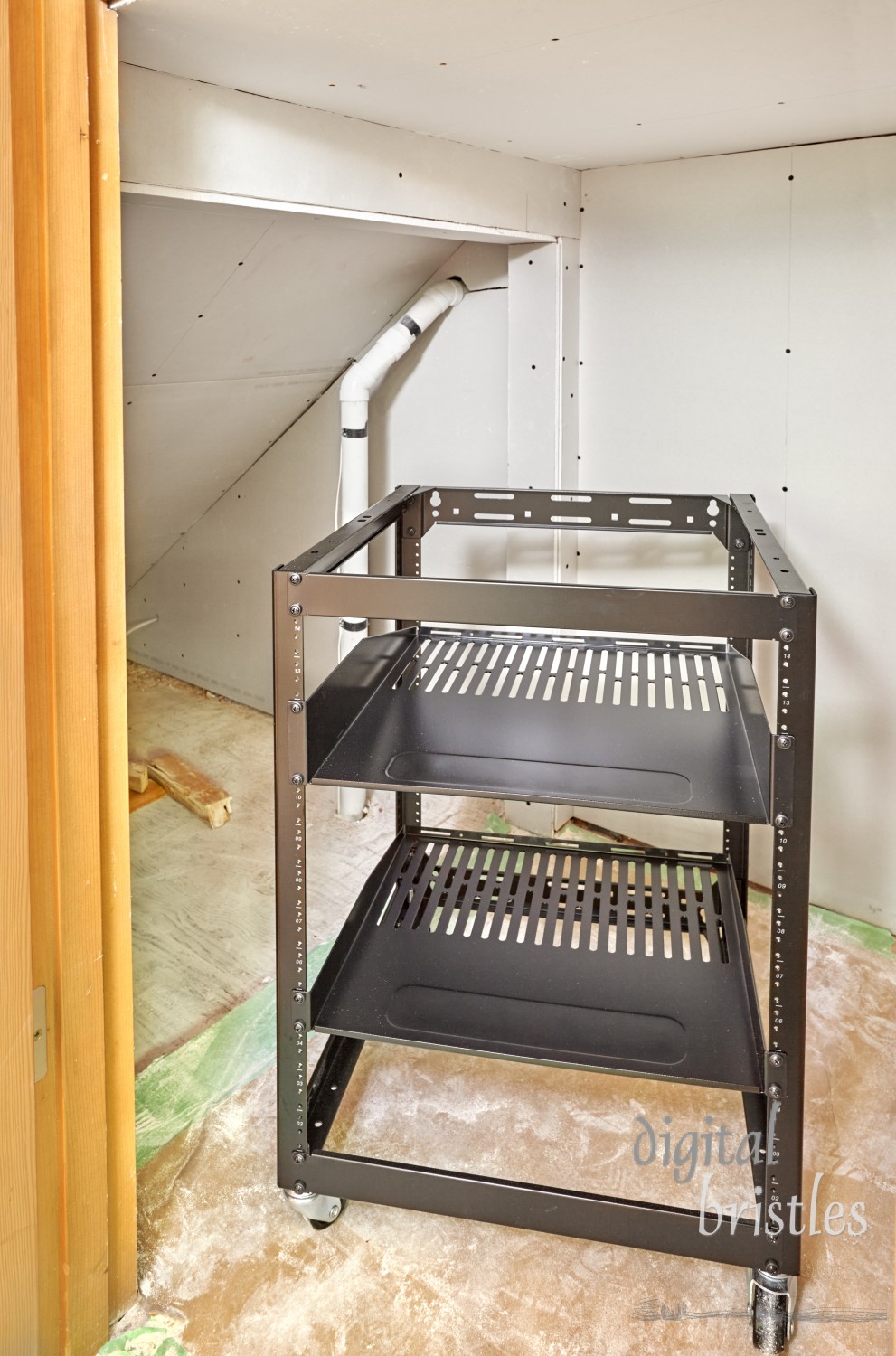 Rolling equipment rack for under stair network closet. Drywall installed. 