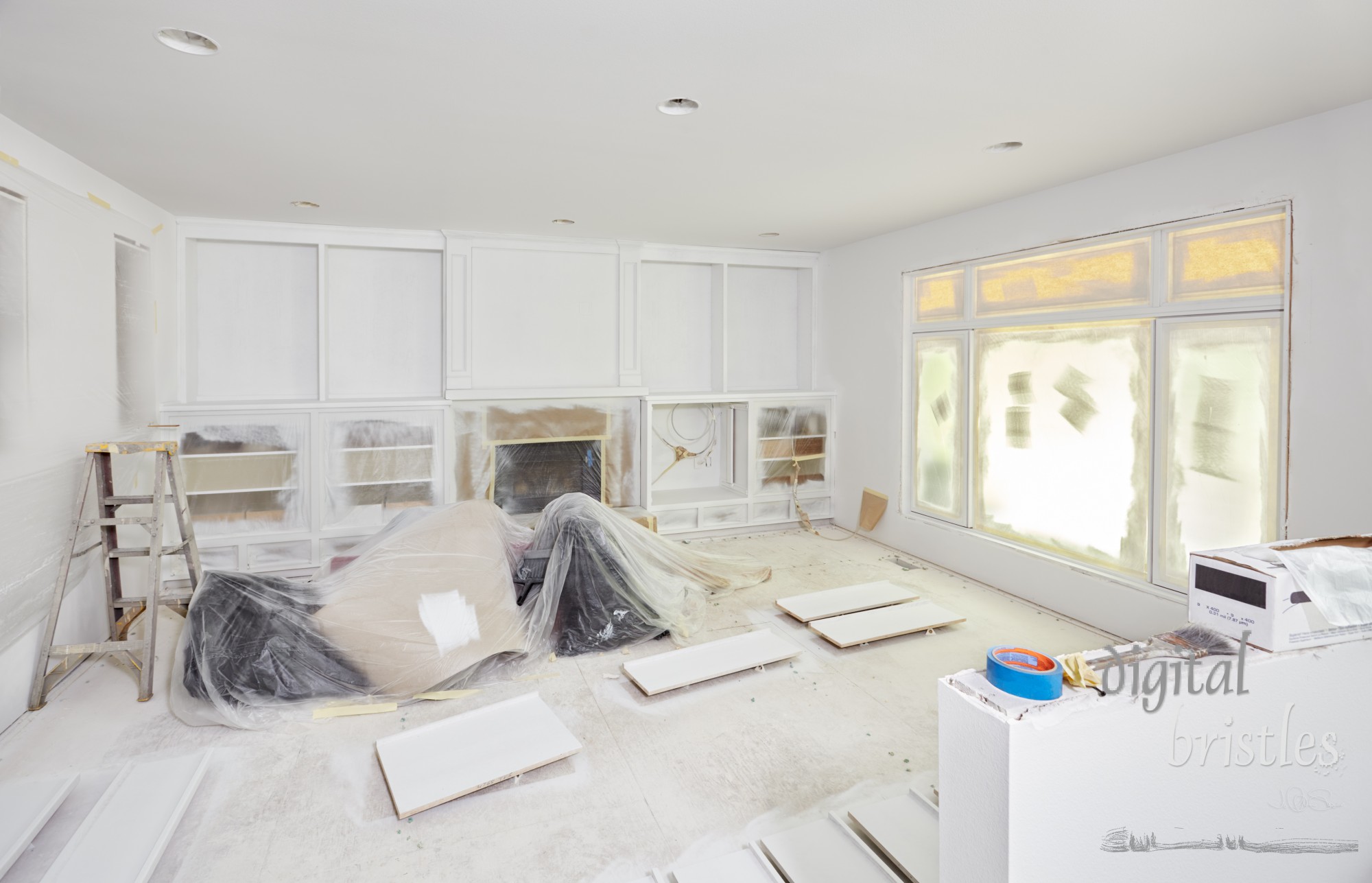 Trim painting in the family room has windows and cabinets plastic wrapped and taped