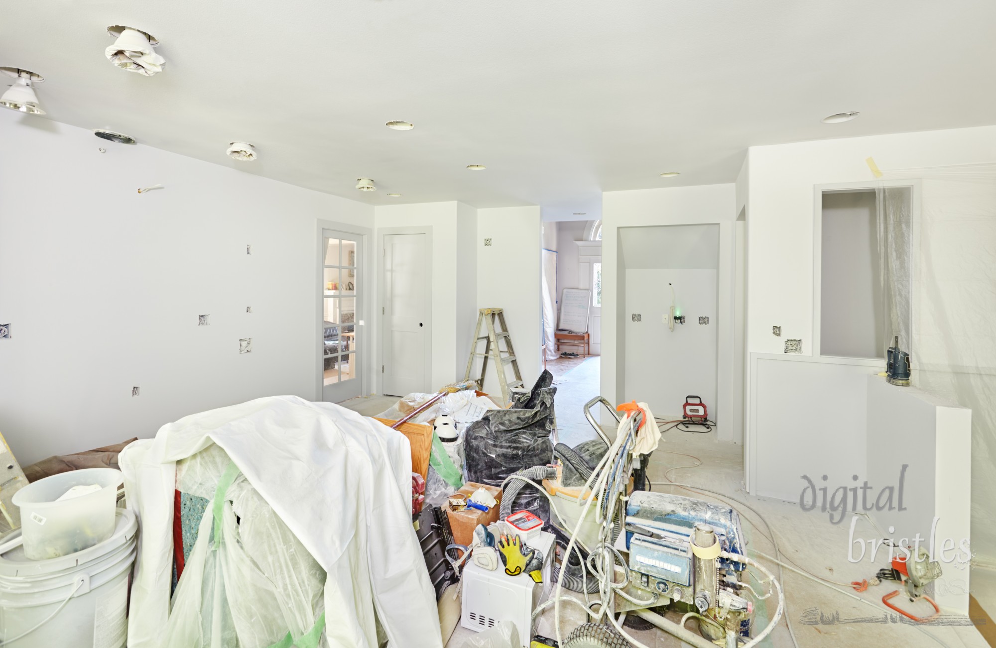 During priming and painting, tools, supplies, trash and some wrapped appliances are shoved in the center of the kitchen