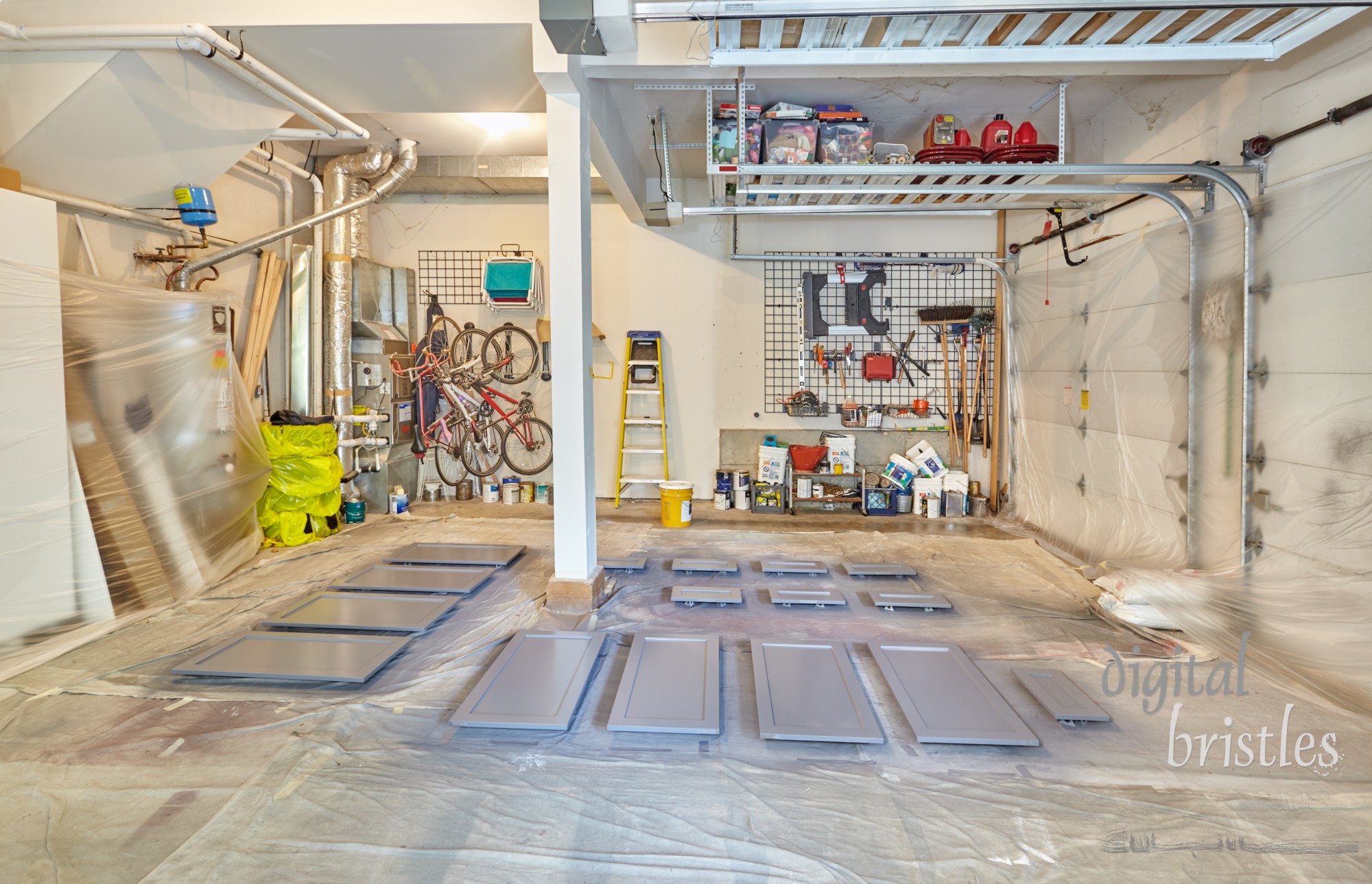 Cabinet doors and drawer fronts drying after being spray painted in the garage