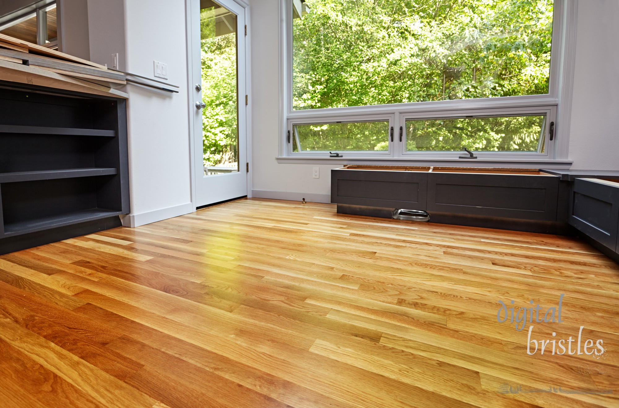 Oal kitchen floor refinished and window seat storage benches partially installed.