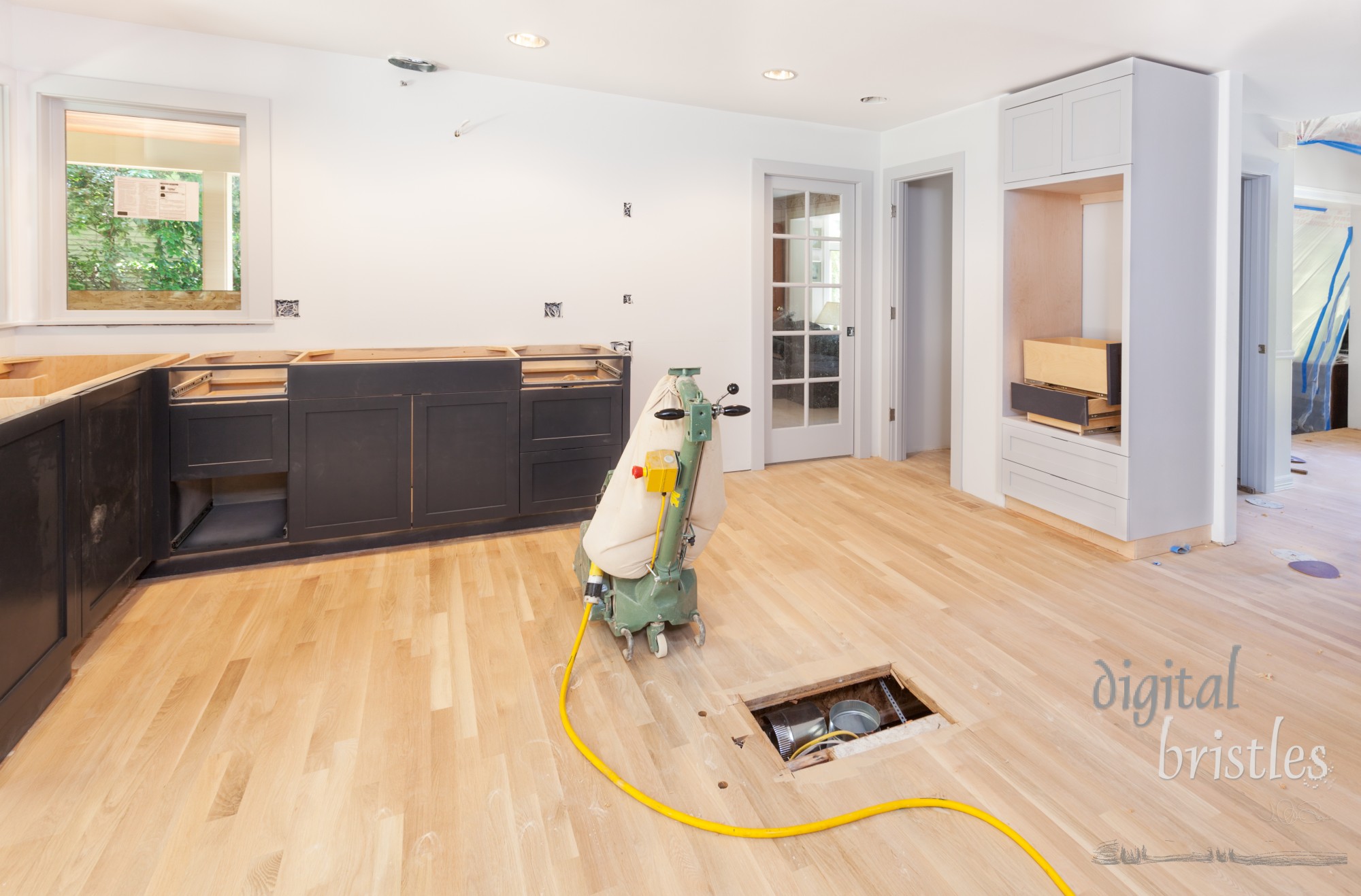 Filler is applied and sanded off to refinish a 20-year-old hardwood kitchen floor