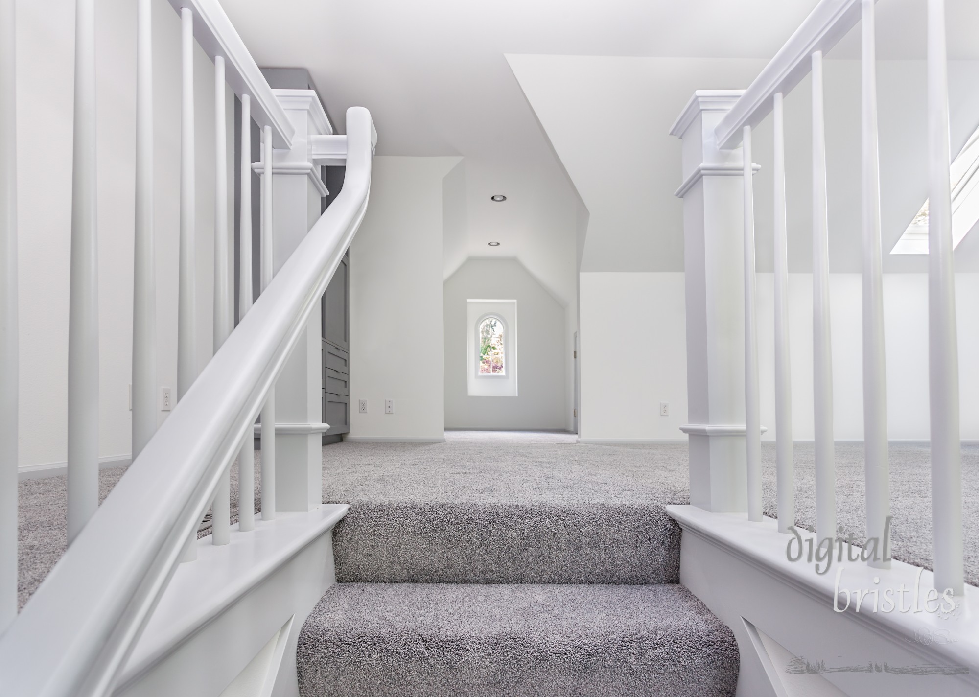 Custom stairs and railings are now carpeted and painted