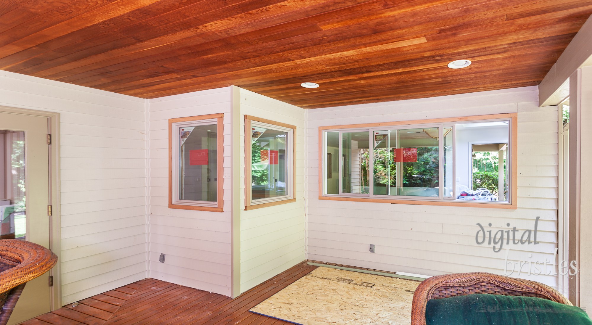 Siding is patched and trim added to new kitchen windows overlooking deck