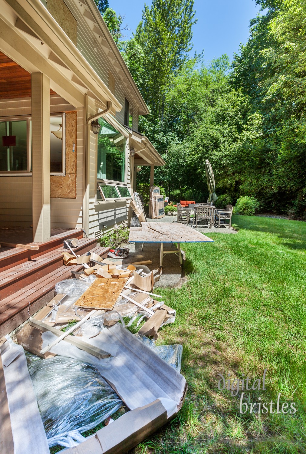 Window installation during home remodel with back garden as staging area