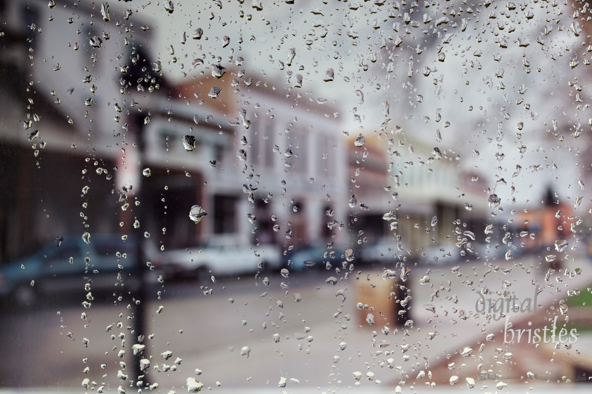 Raindrops on a window looking at an Old Sacramento Street